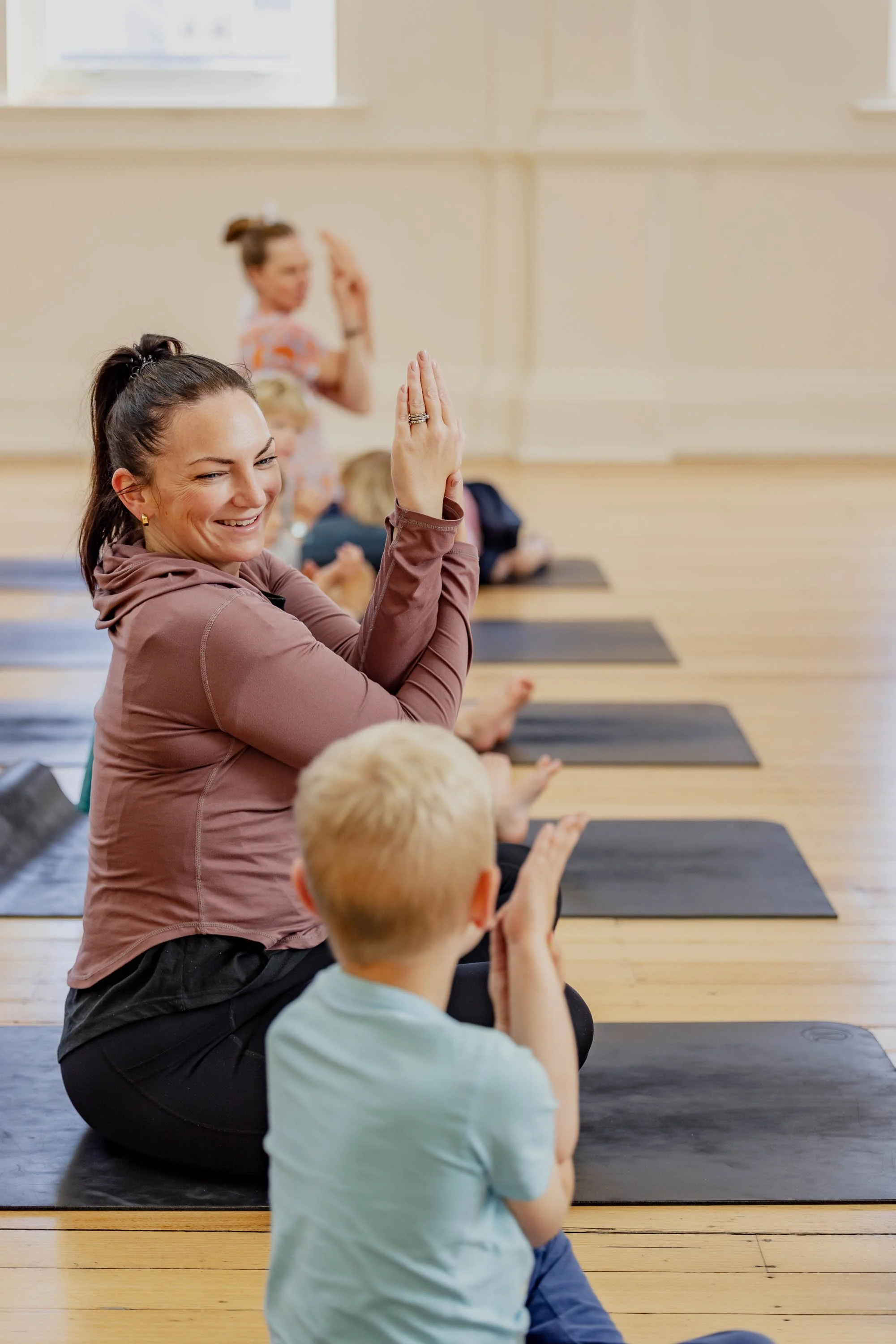 Mother looking at child doing yoga
