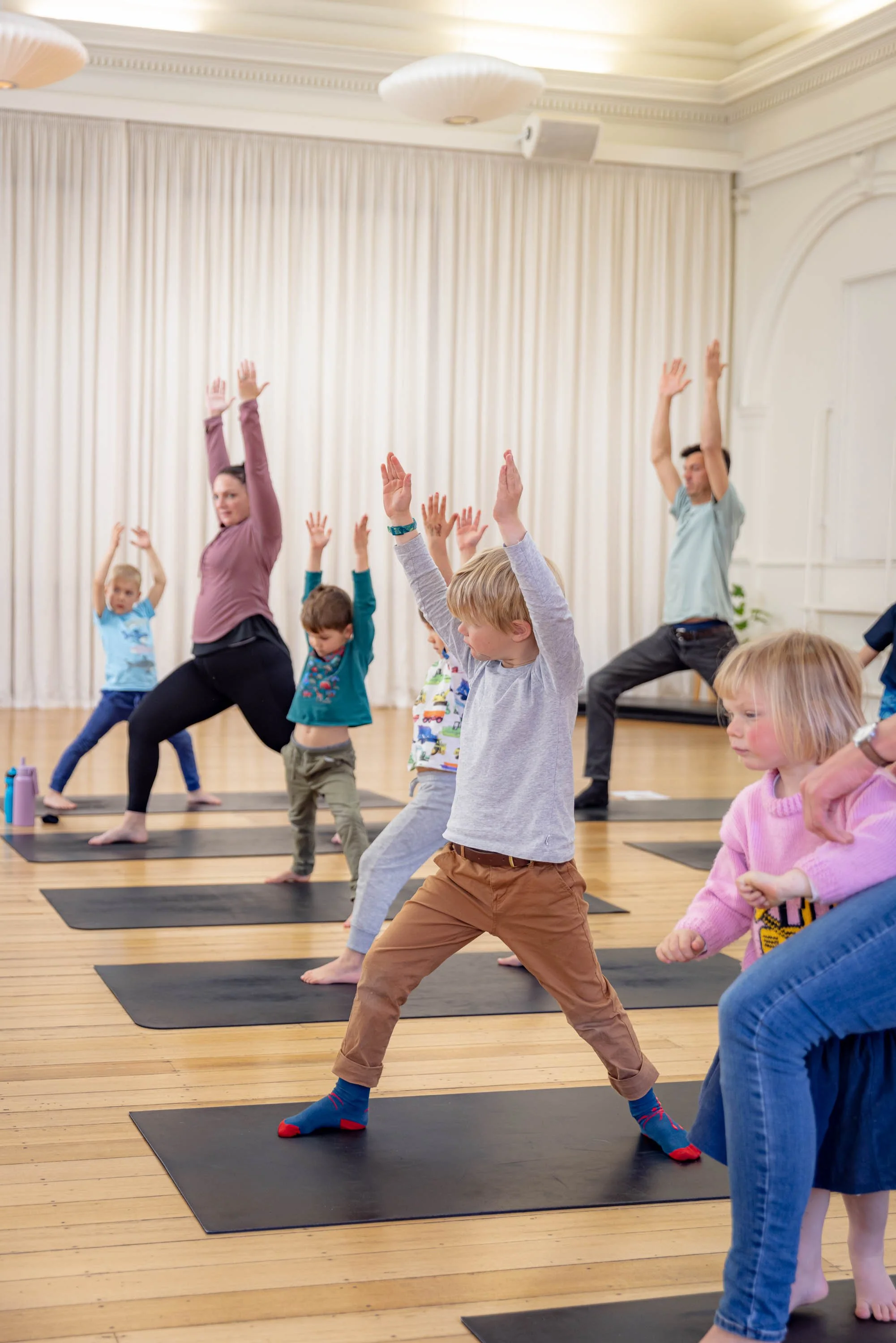 Children and parents doing yoga