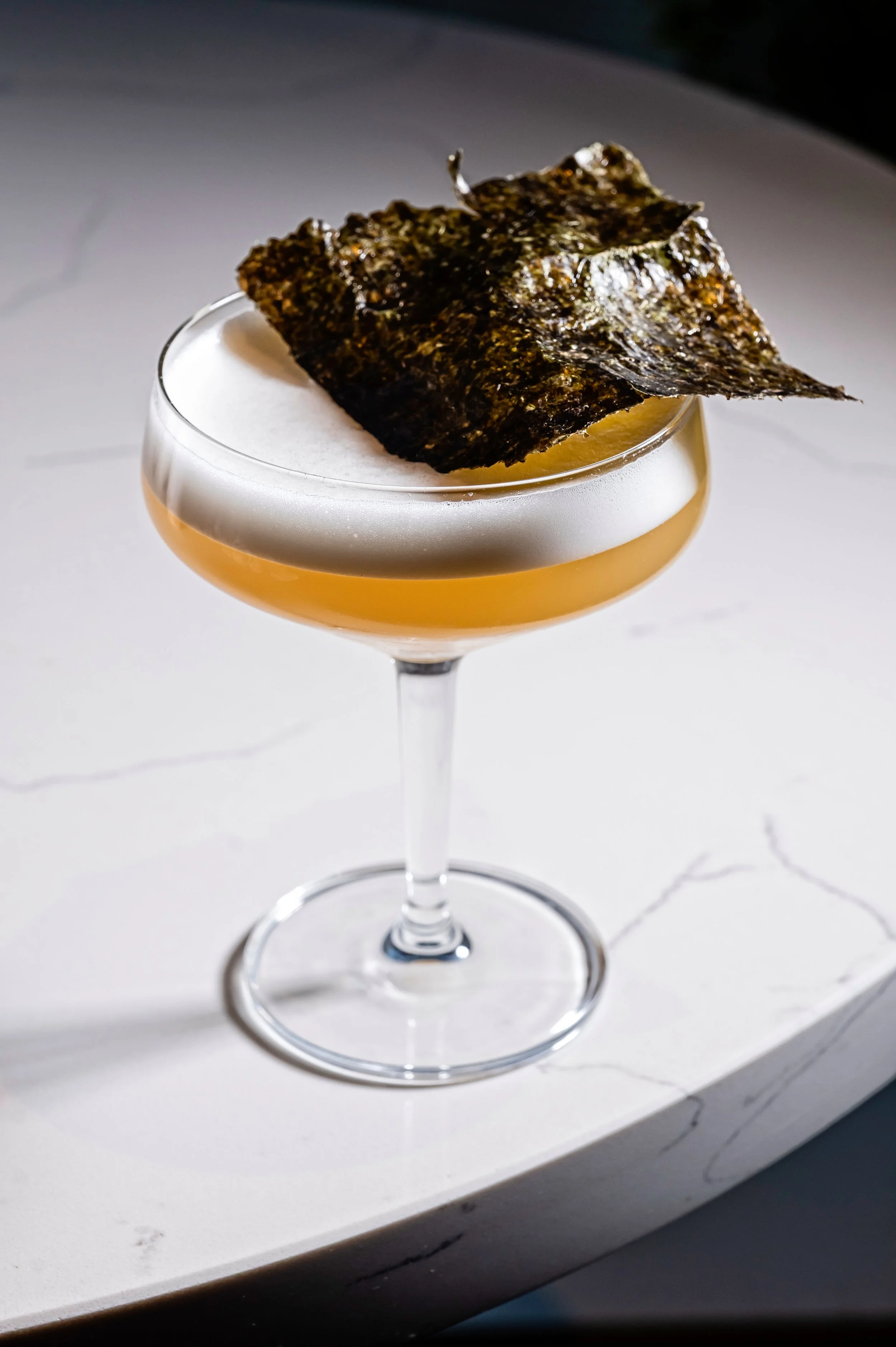  LLAMAS IN JEOLLA  A house cocktail of perilla-washed pisco, green plum, and brown rice vinegar, finished with a silky egg white foam and a roasted gim (seaweed) garnish.