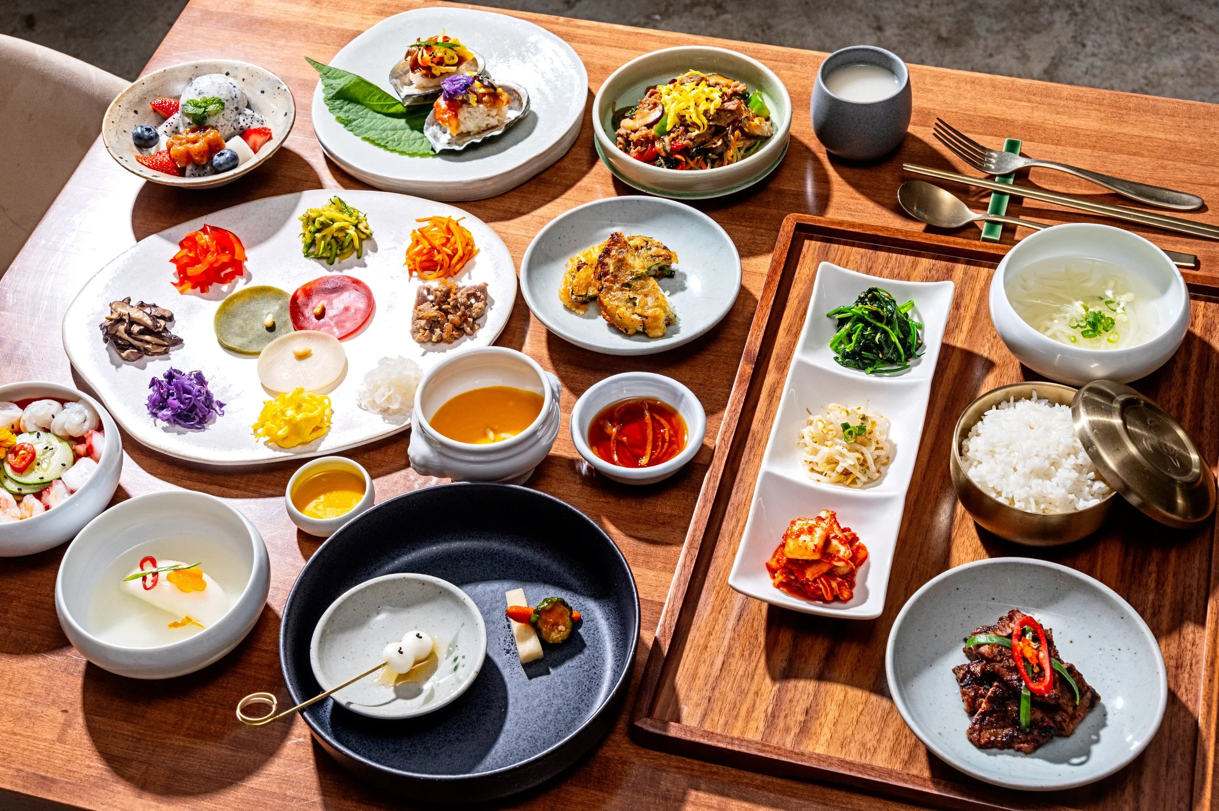 A full Hanjeongsik 6-course meal at Onggi in Washington DC, featuring a variety of traditional Korean dishes including soups, grilled meats, vegetables, rice, and banchan. A thoughtfully prepared multi-course dining experience showcasing the depth an