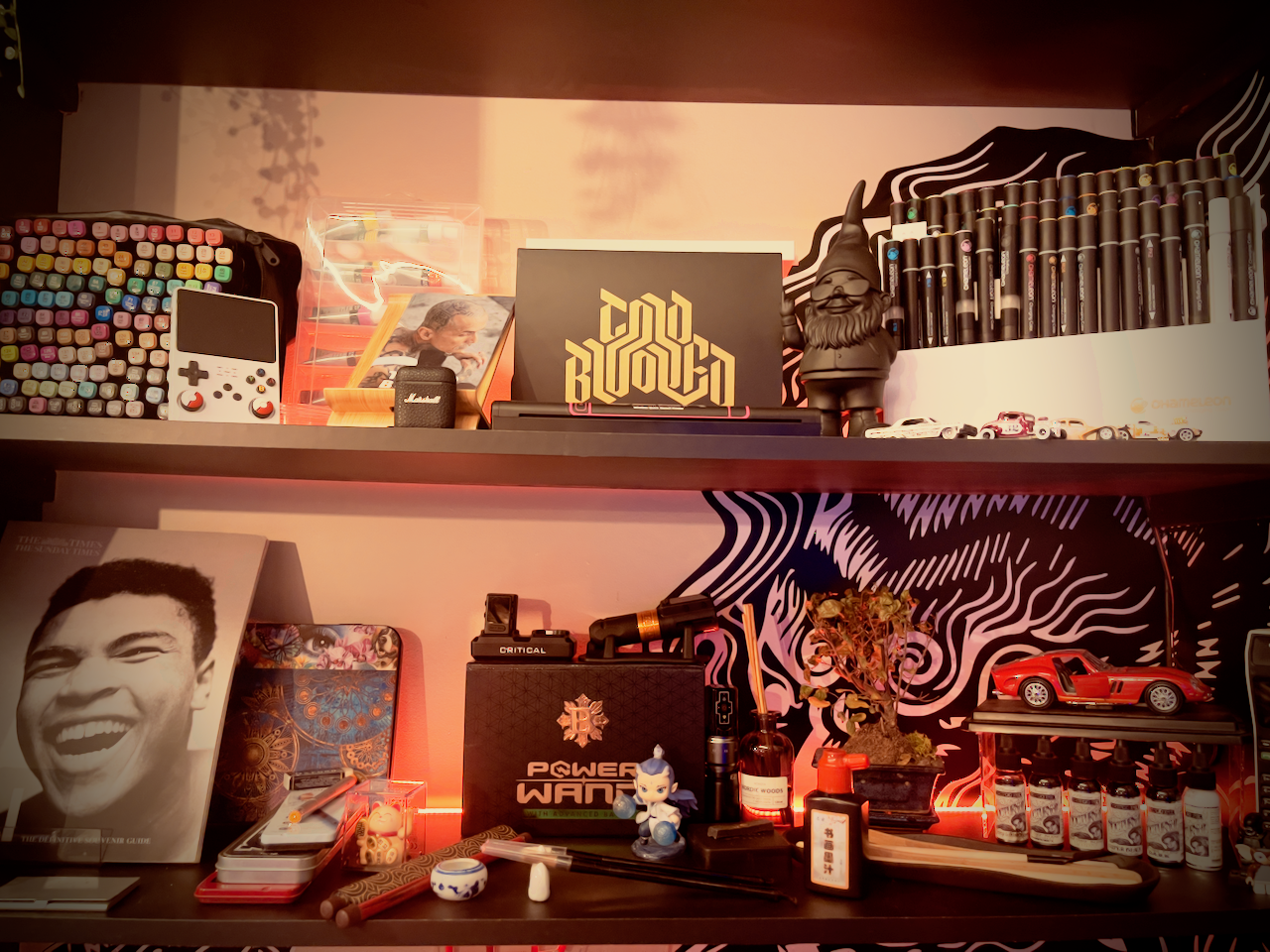 Kuroko Ink shelf display with artwork, books, and studio decor