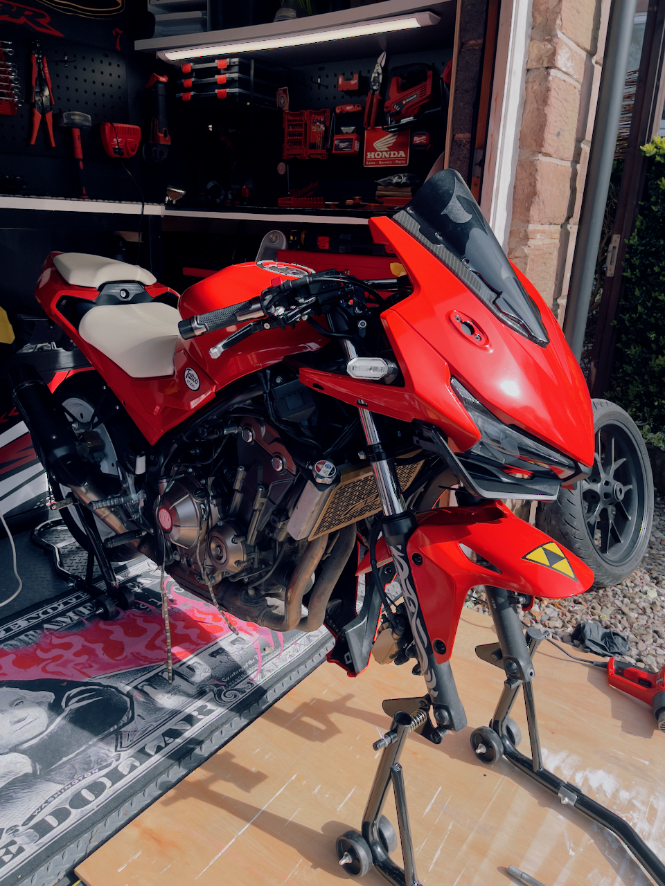 Red Kuroko Akira-inspired motorbike in the workshop during the build