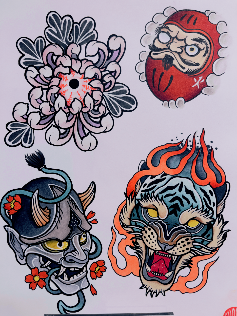 Traditional Japanese tattoo flash sheet with chrysanthemum, Daruma, hannya mask, and tiger head