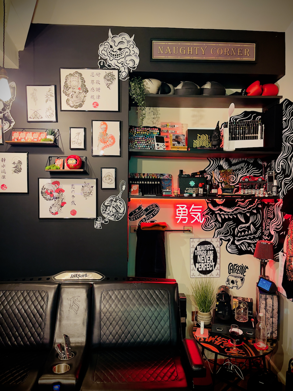 Studio wall with framed flash, dragon artwork, and display decor