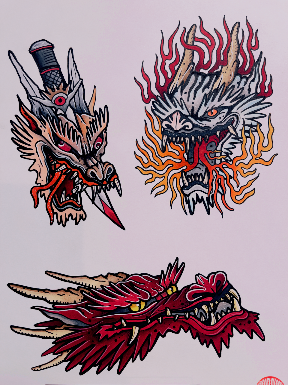 Three colorful tattoo-style dragon and demon head illustrations on a white background.