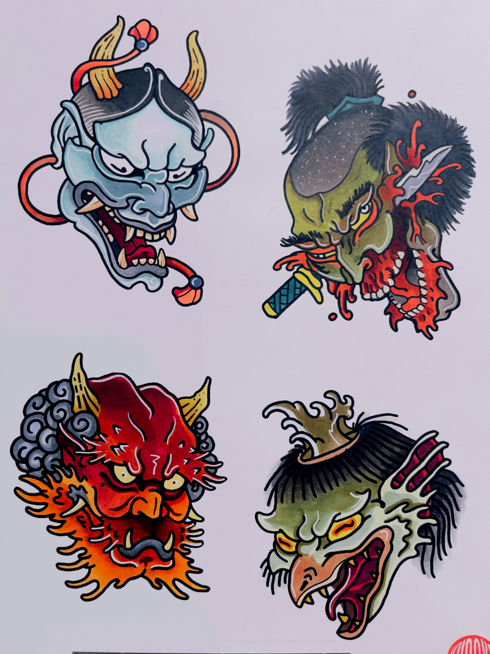 Traditional Japanese tattoo flash sheet with oni masks and yokai-style faces