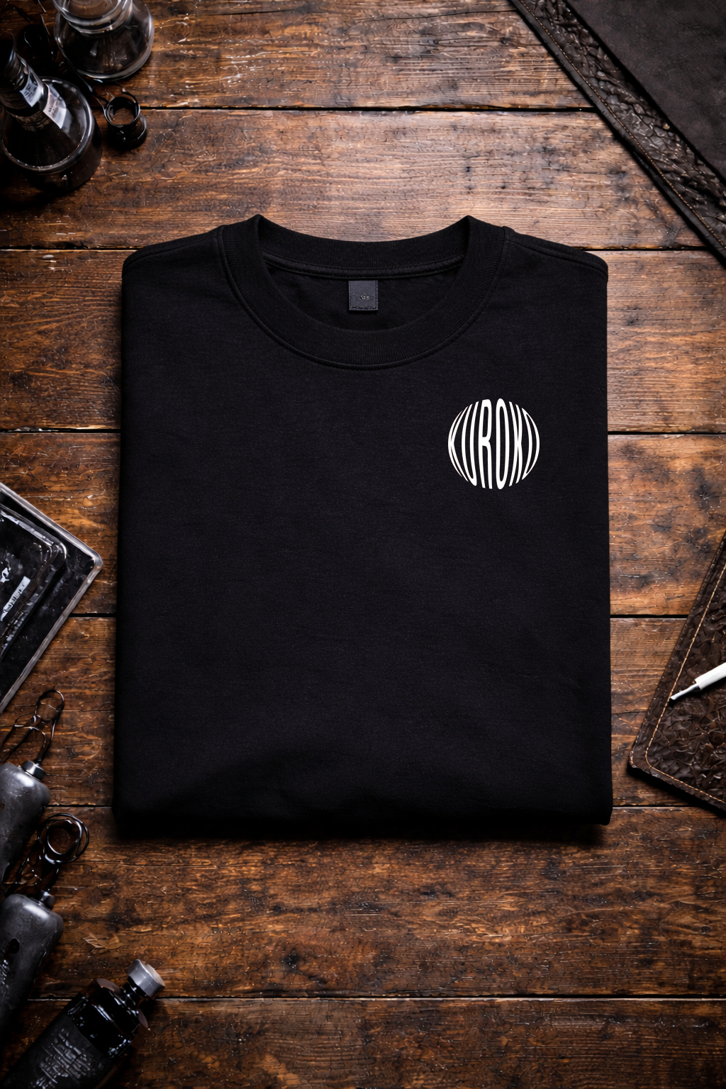 Folded black Kuroko Ink T-shirt with small chest logo