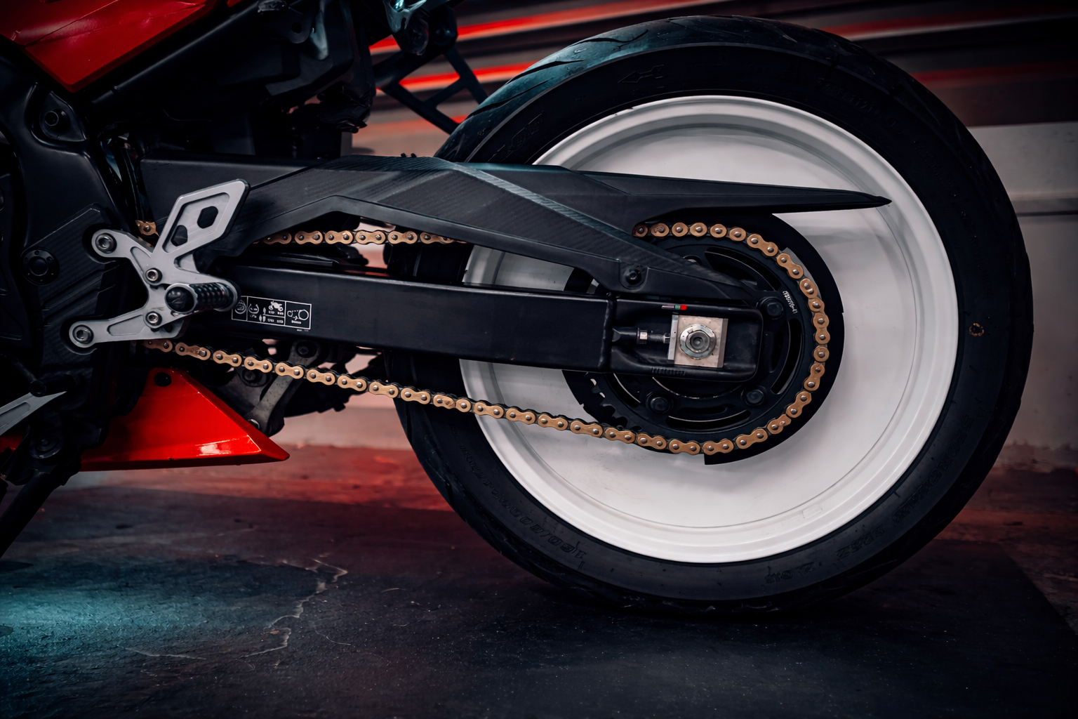 Close-up of sport motorcycle wheel and chain.png