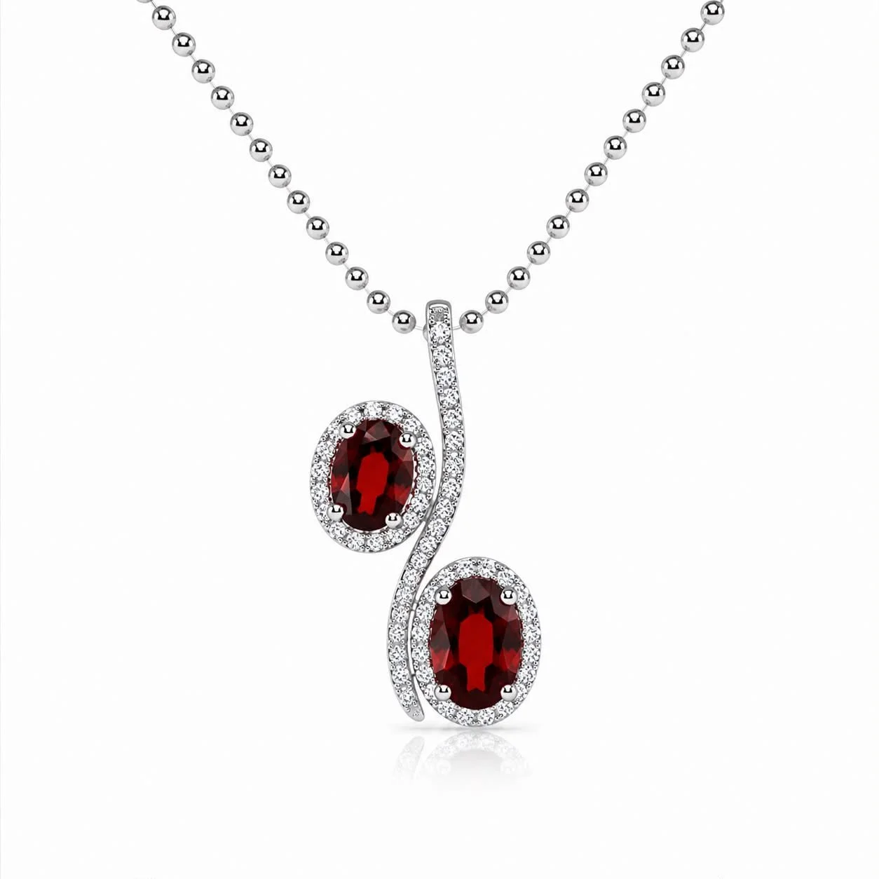 Silver necklace with a pendant featuring two oval red gemstones surrounded by small diamonds on a white background.