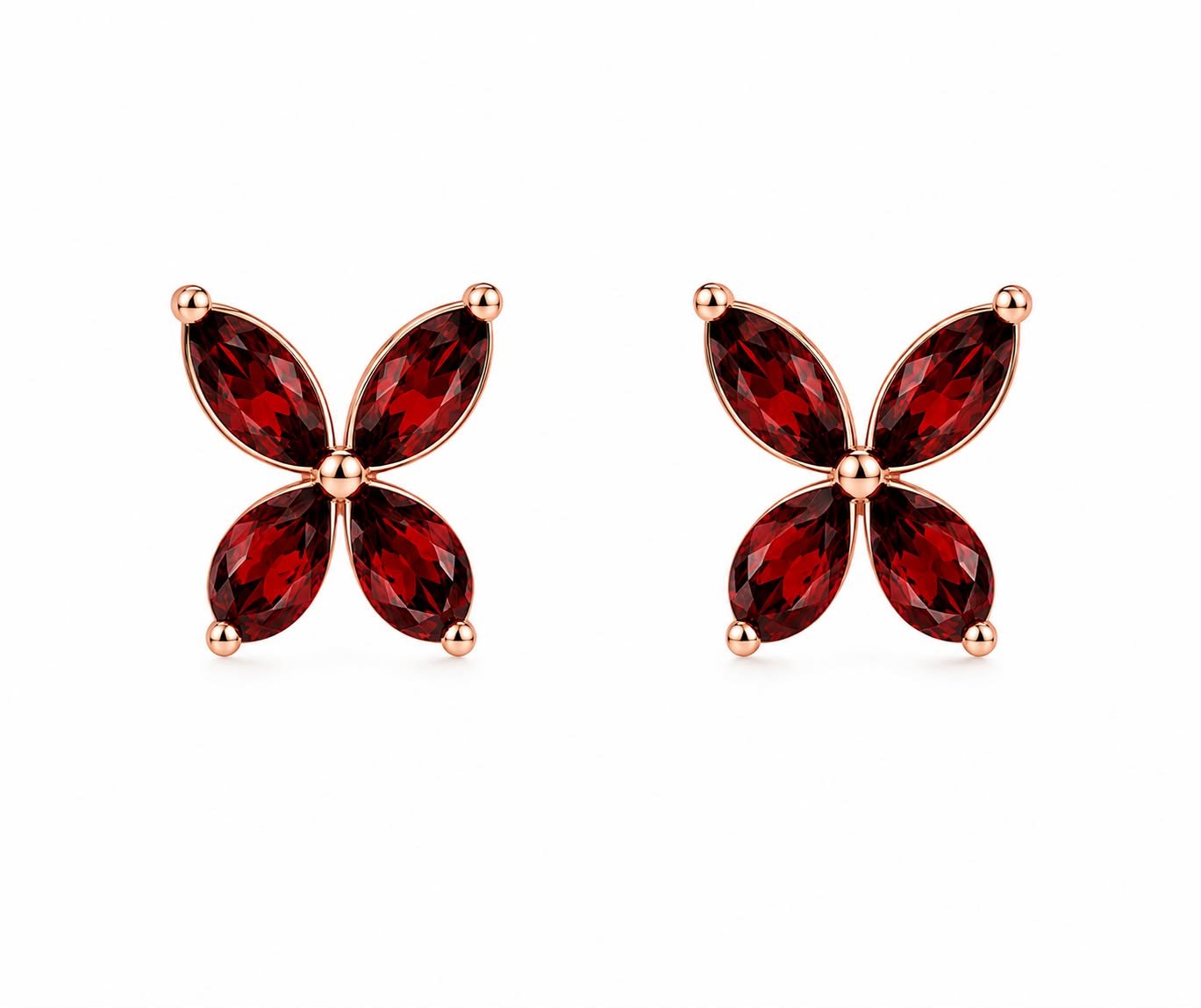 Pair of butterfly-shaped earrings with red gemstones and rose gold settings on a white background.
