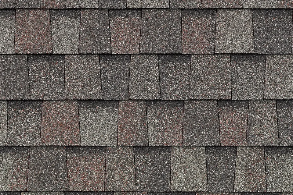 Close-up of a shingle roof with several layers of asphalt shingles.