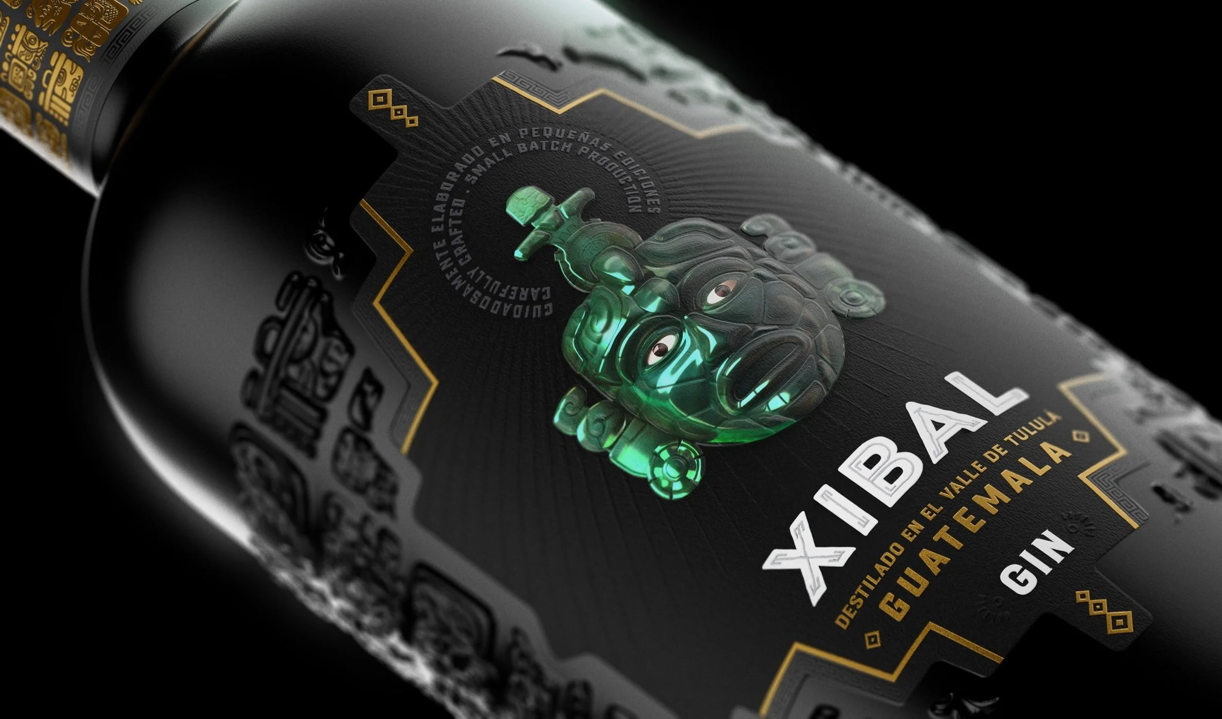 Angled view of Xibal Gin bottle with embossed jade mask, gold-accented Mayan motifs, and white typography on matte black label — handcrafted Guatemalan gin with cultural premium branding.