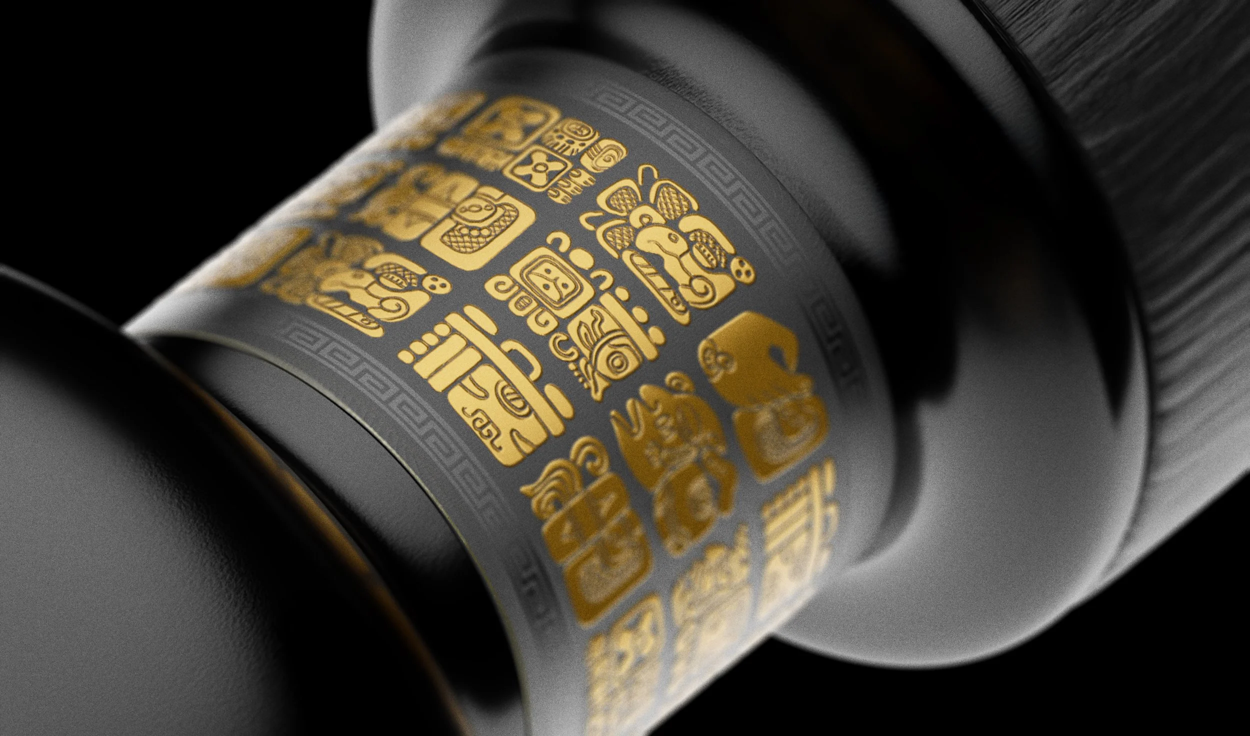 Close-up of Xibal Gin bottle neck featuring gold Mayan glyphs on matte black surface — showcasing indigenous-inspired design, cultural storytelling, and premium spirits packaging.