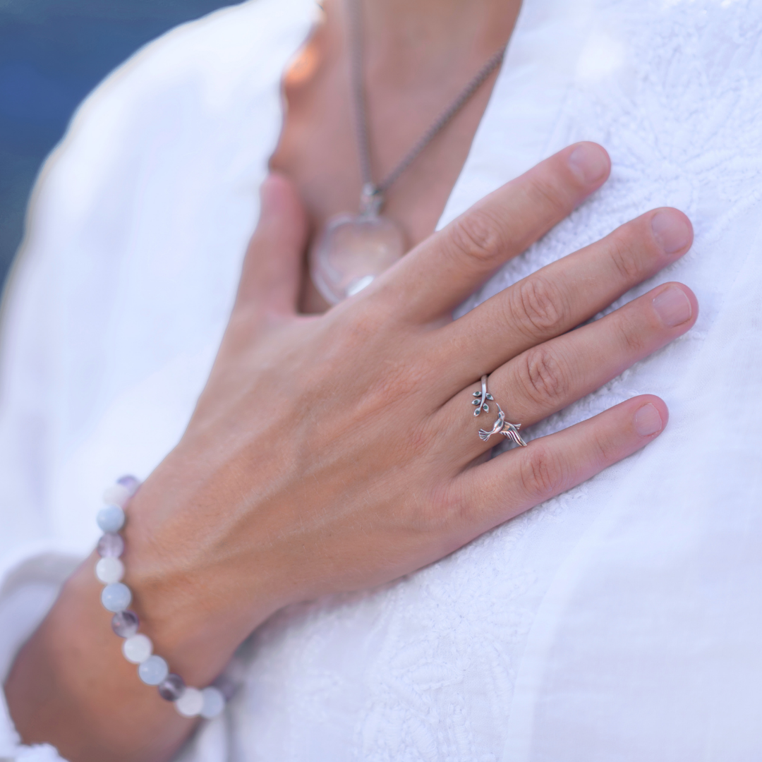 Close-up of a woman's hand resting over her heart
