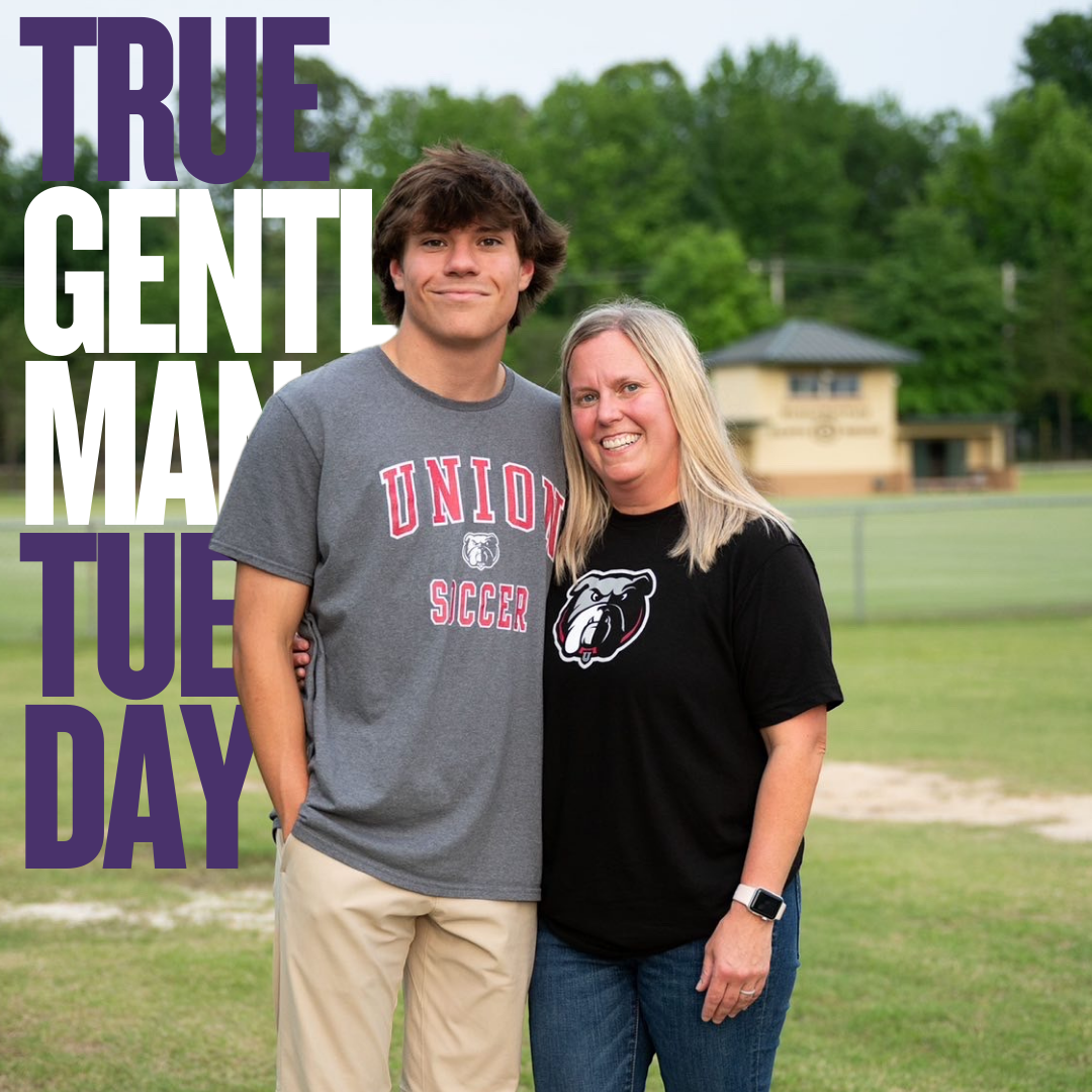 A young man and a woman standing together on a grassy field, smiling at the camera. The young man is wearing a gray shirt with "UNION SOCCER" and a bear logo, while the woman is wearing a black shirt with a bear logo. The background features trees and a small building. Text overlays say "TRUE GENTLEMAN TUB DAY".