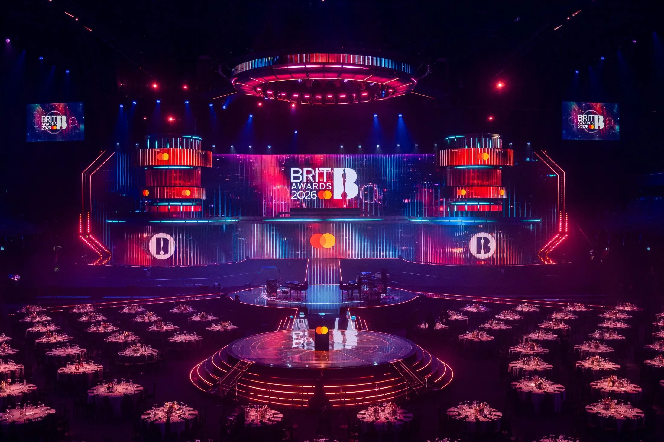 Picture of set venue stage for Brits awarads 2026 all lit up in blue, pink, purple colours