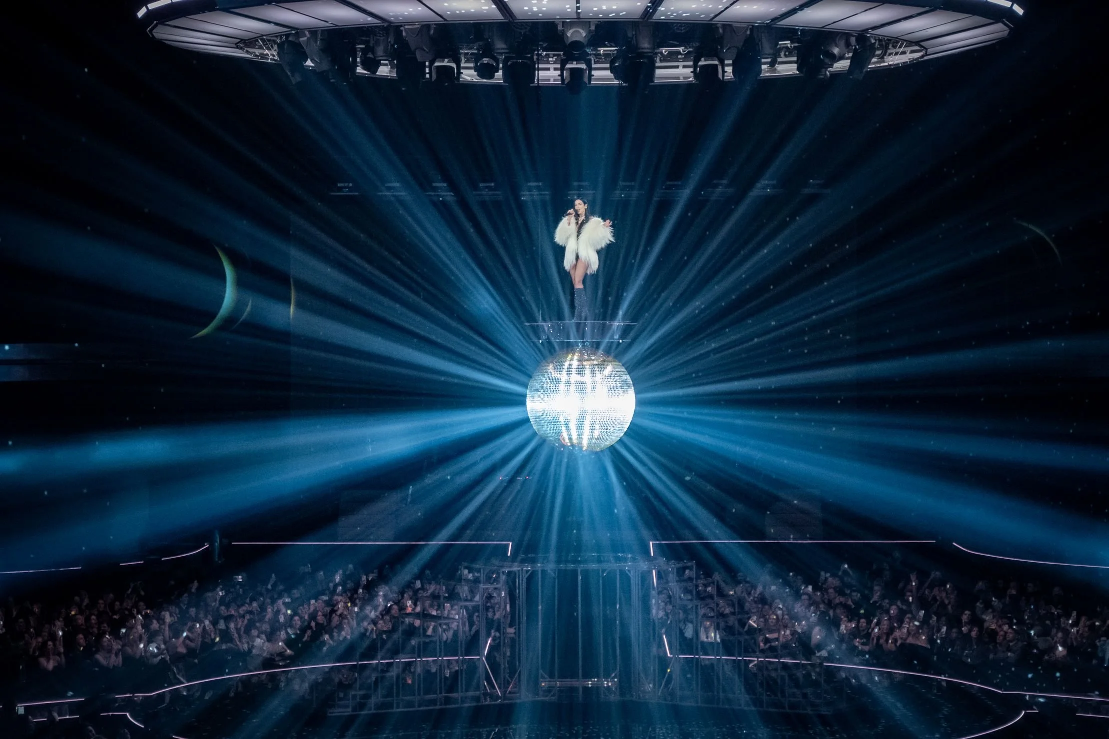 singer above big disco ball floating in the air on platform, custom made stage, performance