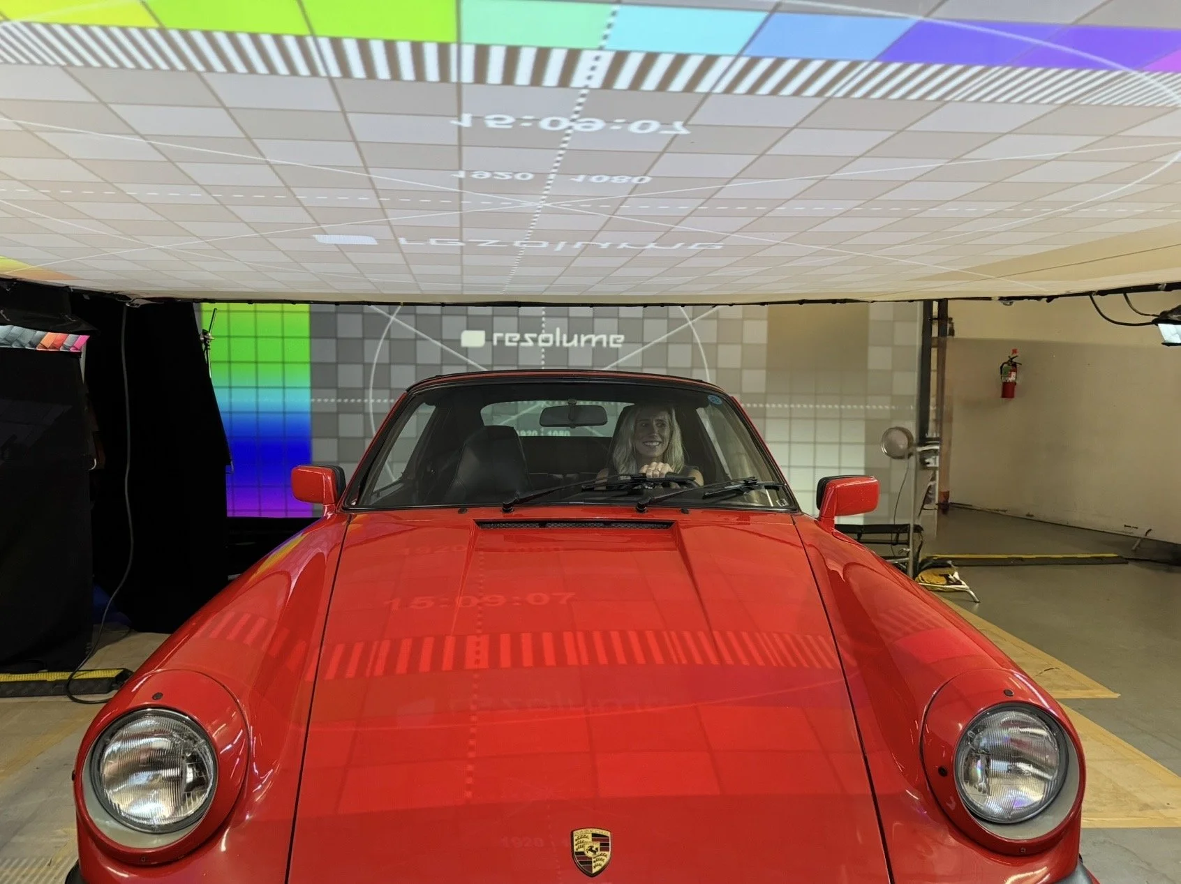 Actress performing dialogue scene inside a car during a controlled rear projection driving setup in Los Angeles studio