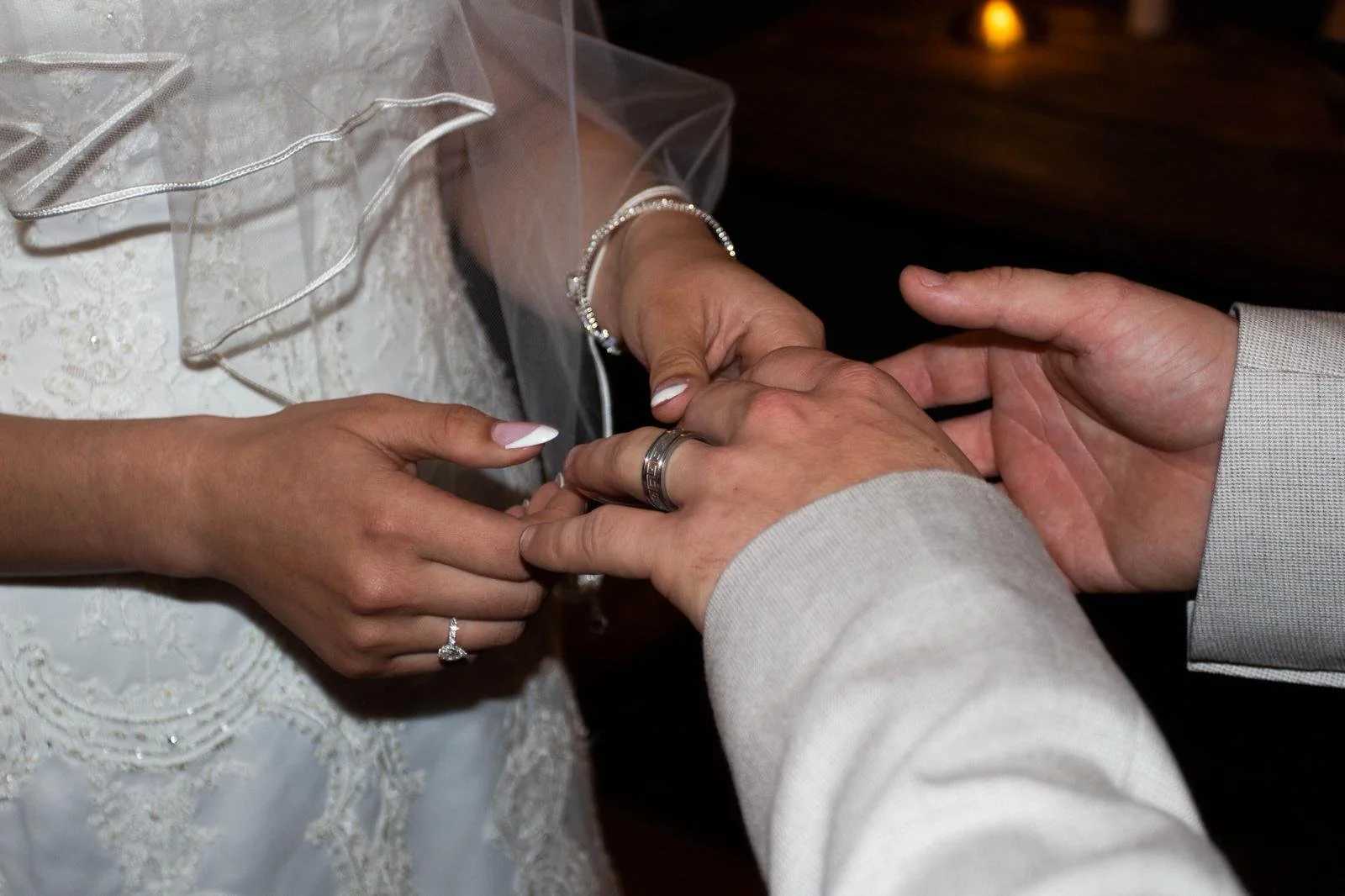 bride and groom placing rings on fingers during ceremony