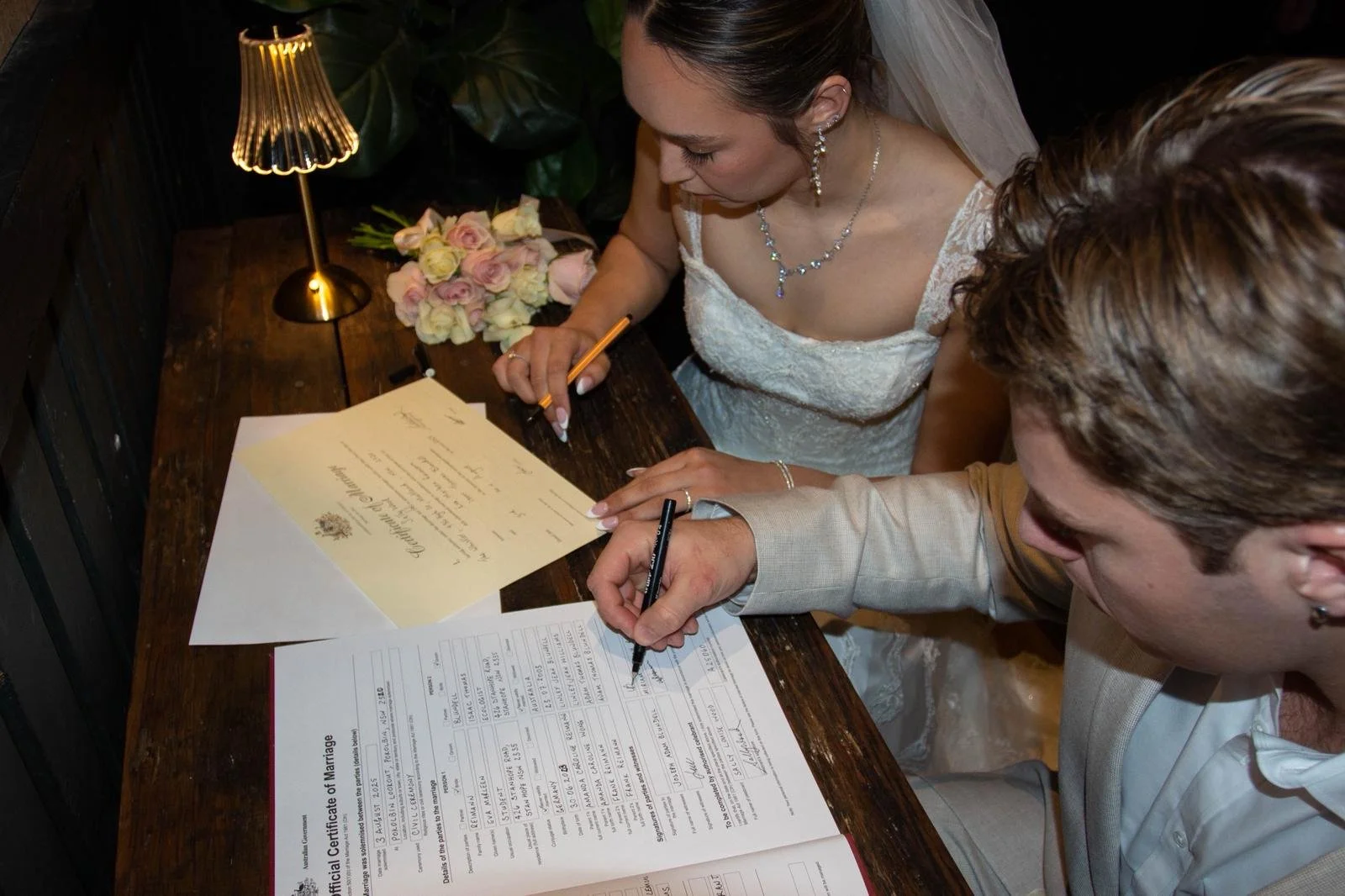bride and groom signing the register