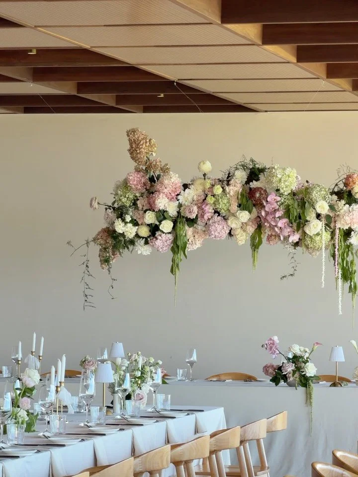the soft blush and white tonal reception space at The Dairy Ravensbourne for J &amp; M featuring a floral hanging install.
.
@thedairyravensbourne 
@thedairyhiringshed 
@brieconomos_weddings 
@_thevowvault 
@aislesuite 
@jlkmakeupartistry 
@chaiseemm