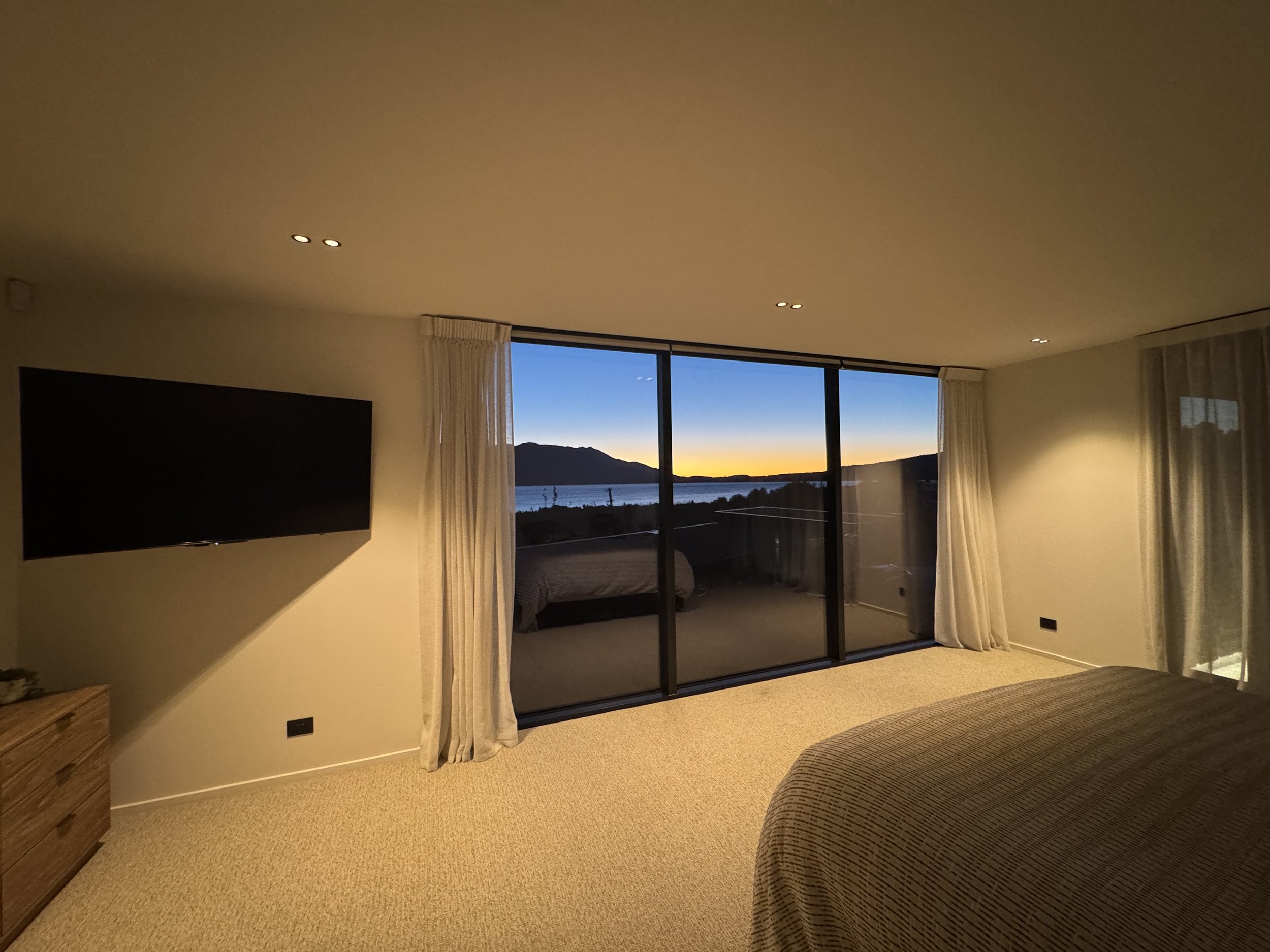 Master bedroom with sunset through window, 3x pairs of downlight