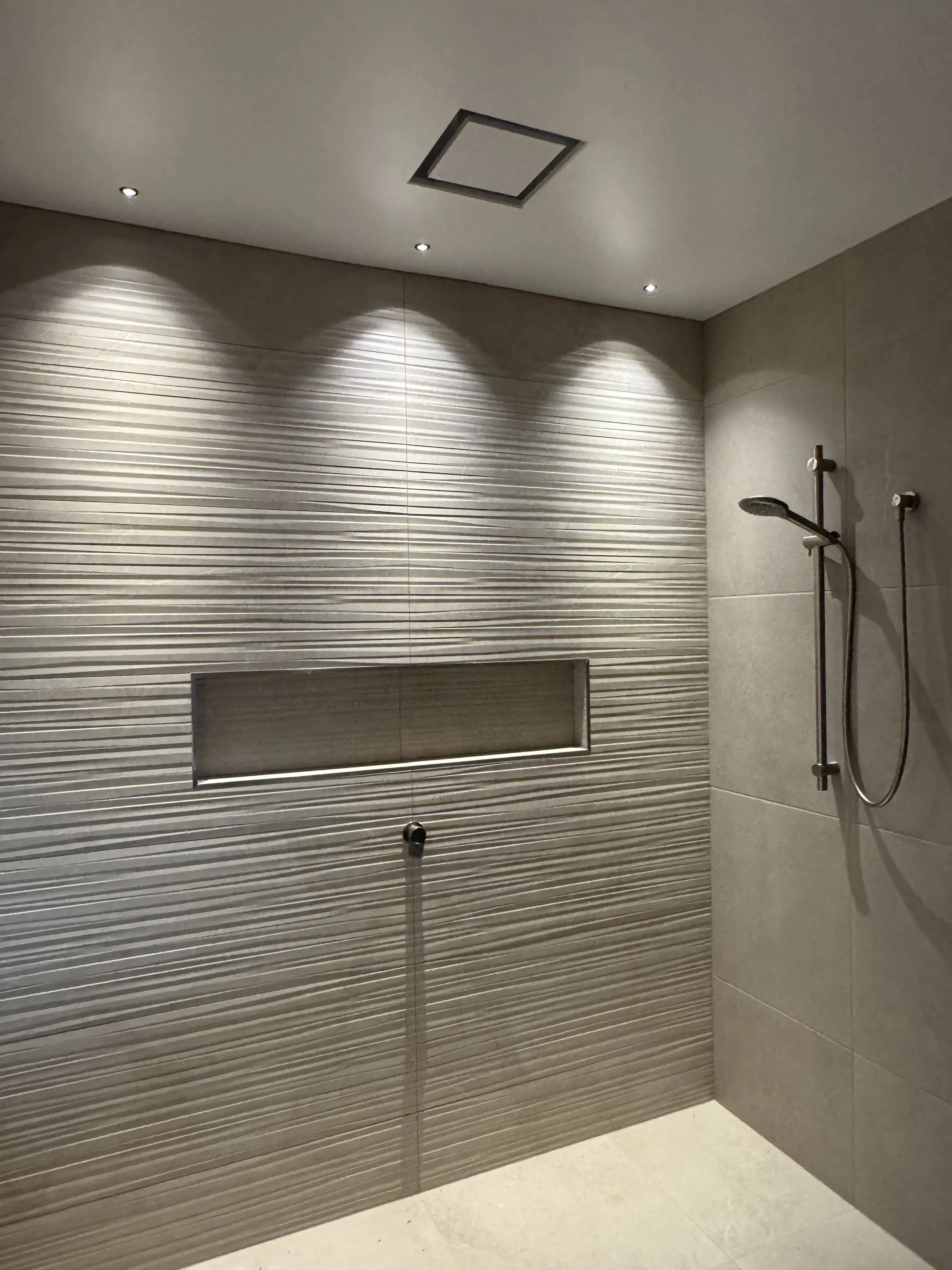 Shower with LED spots highlighting tiles