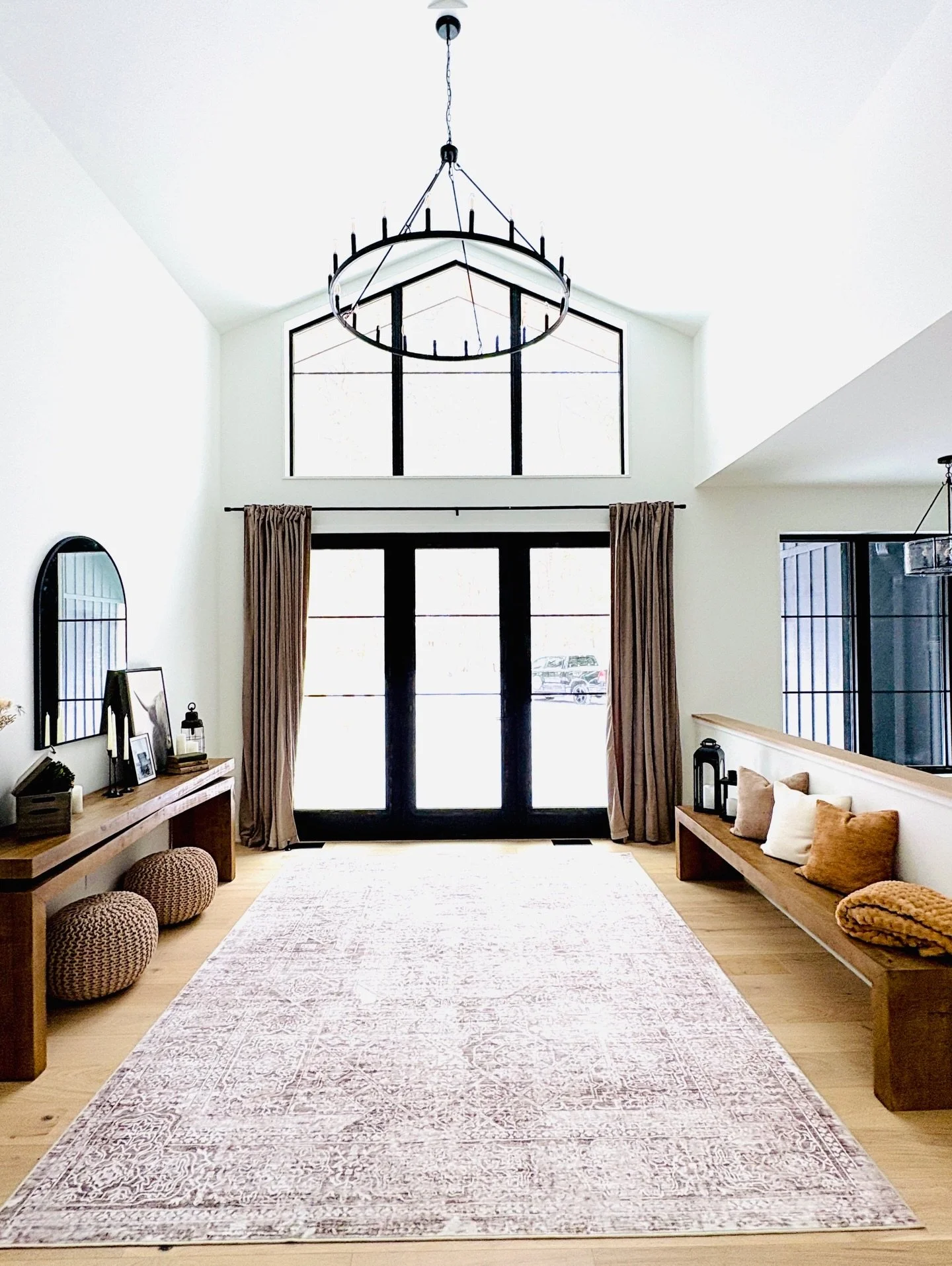 Progress on my Michigan cabin project! Those windows and statement fireplace 🖤🖤🖤 Waiting on a few things like a rug for the sun room sitting area and coffee table in the living room, but it&rsquo;s so cozy and full of my clients personality!