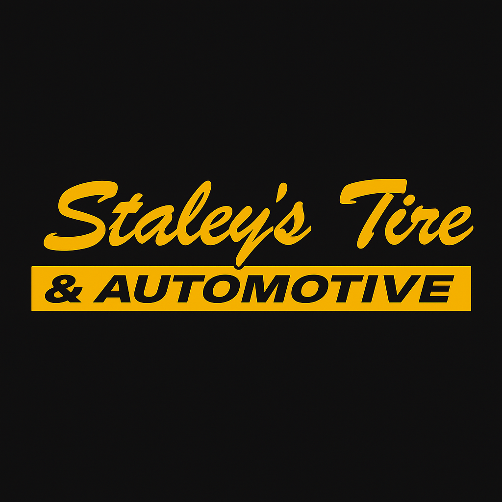 Sign for Staley's Tire & Automotive with yellow lettering on a black background.