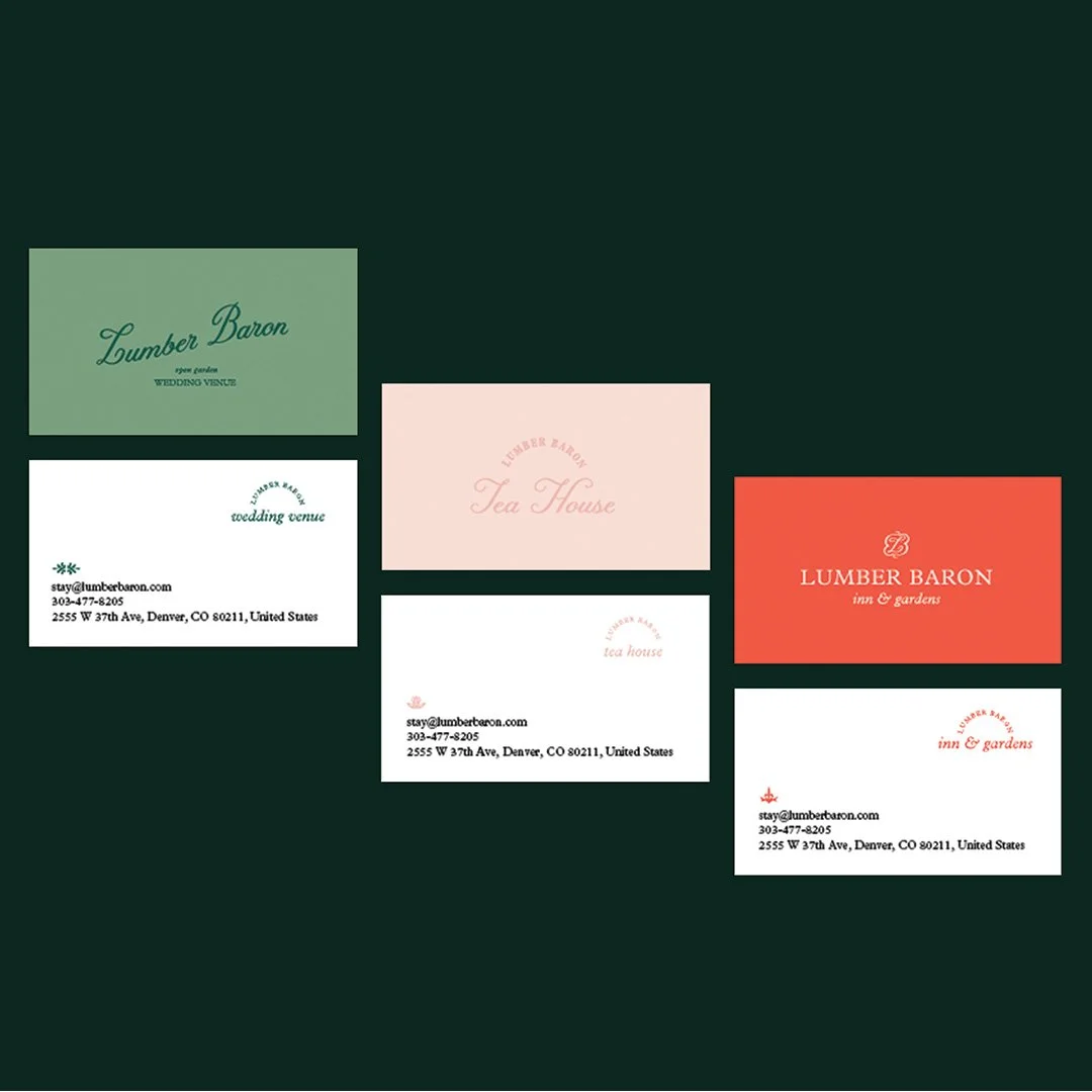 Collection of five business cards for Lumber Baron, a wedding venue, tea house, and inn & gardens, with different colors and fonts, placed on a dark green background.