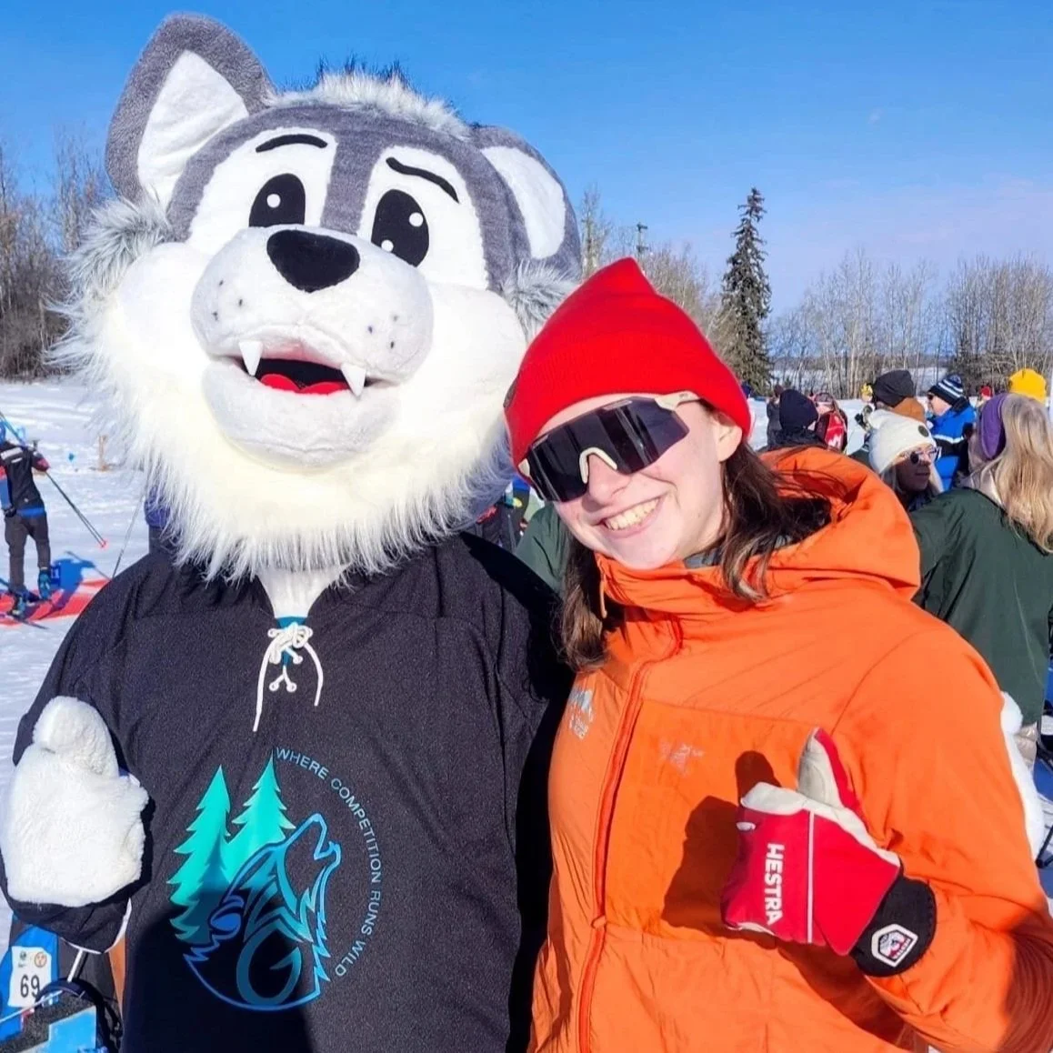Coach in orange jacket with mascot