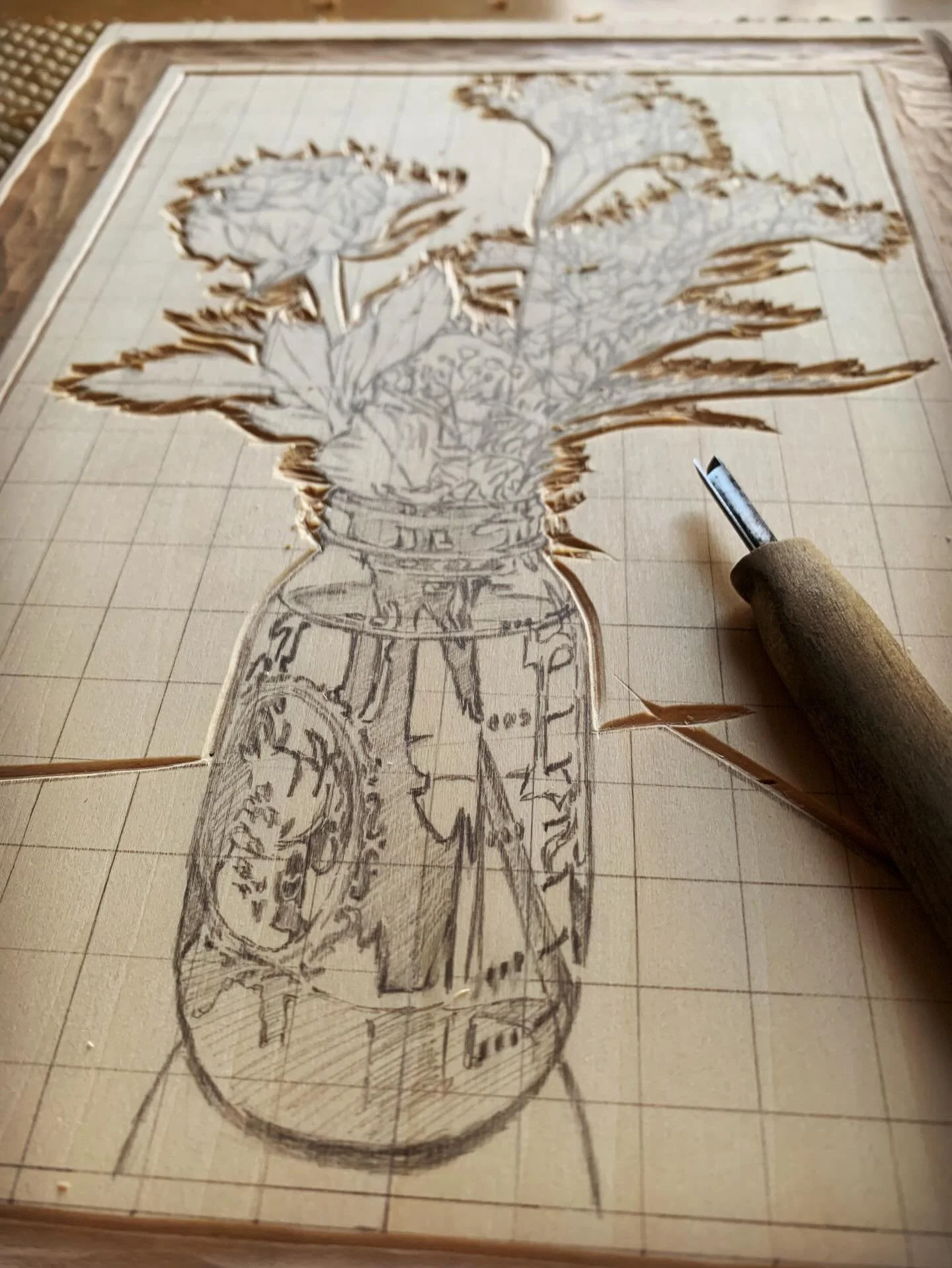 Following the contours of the outer edge to begin the shape of a woodcut print.