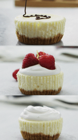Various mini cheesecakes being topped with fruits and chocolate garnishes.