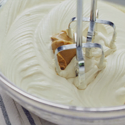 Peanut butter swirling into cream cheese.