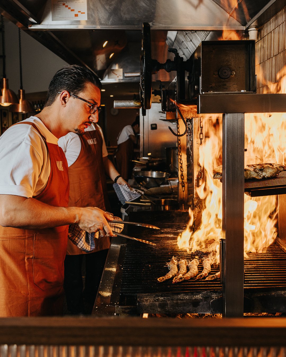Chef, basque grilling share cuts of Margot Osteria