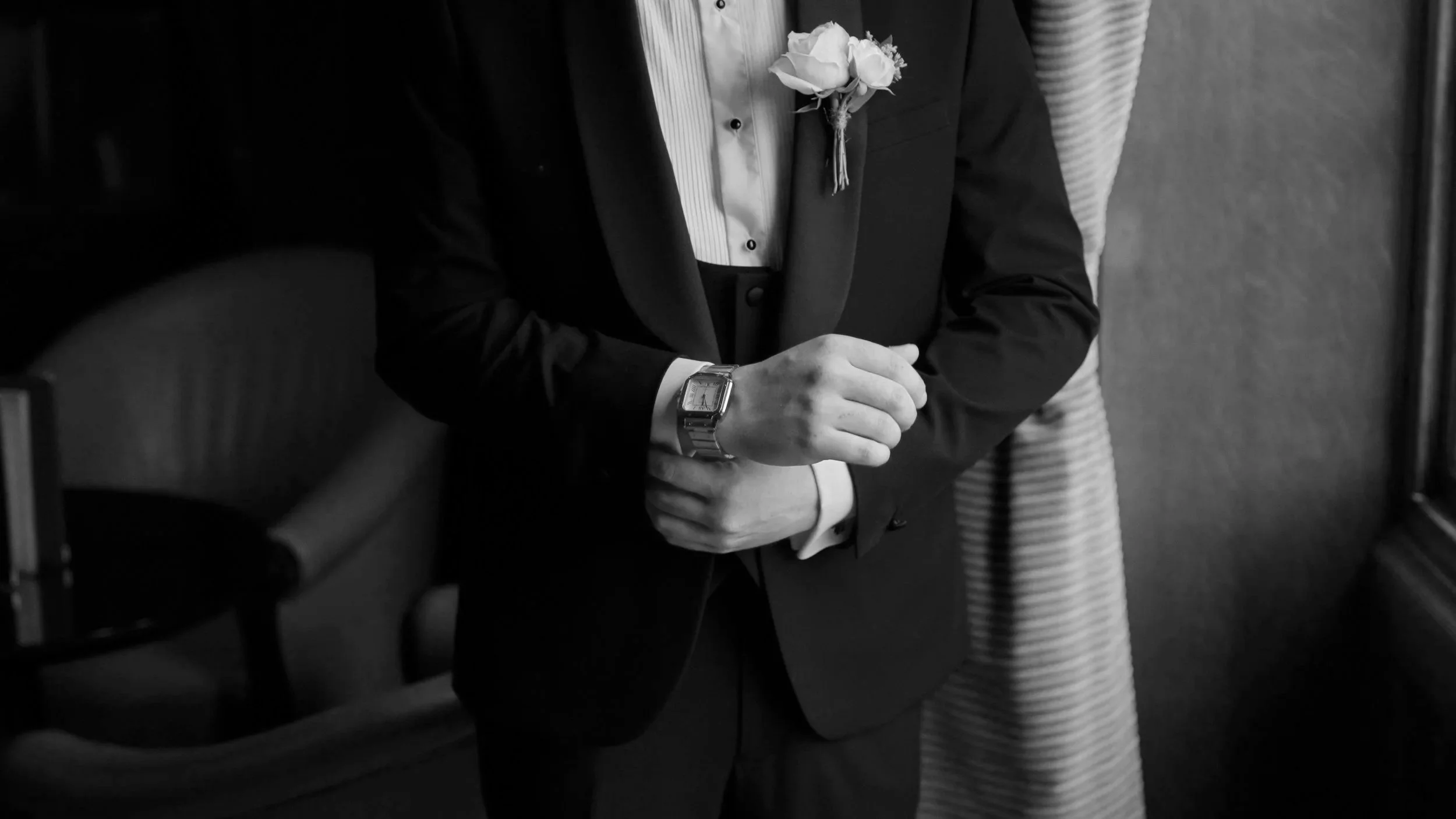 Groom rolling his wrist to display his watch