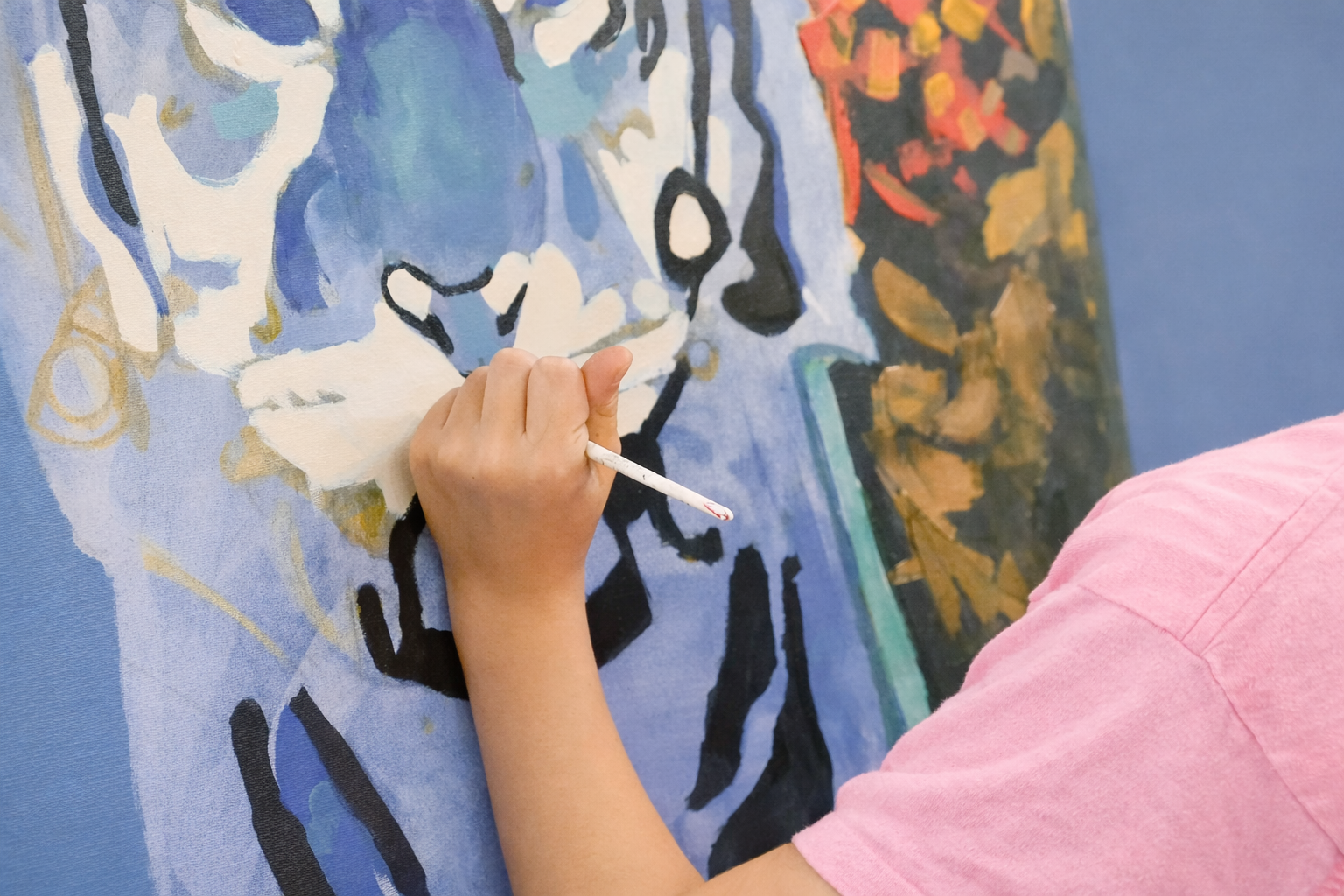 Artist's hand creating an abstract portrait.png