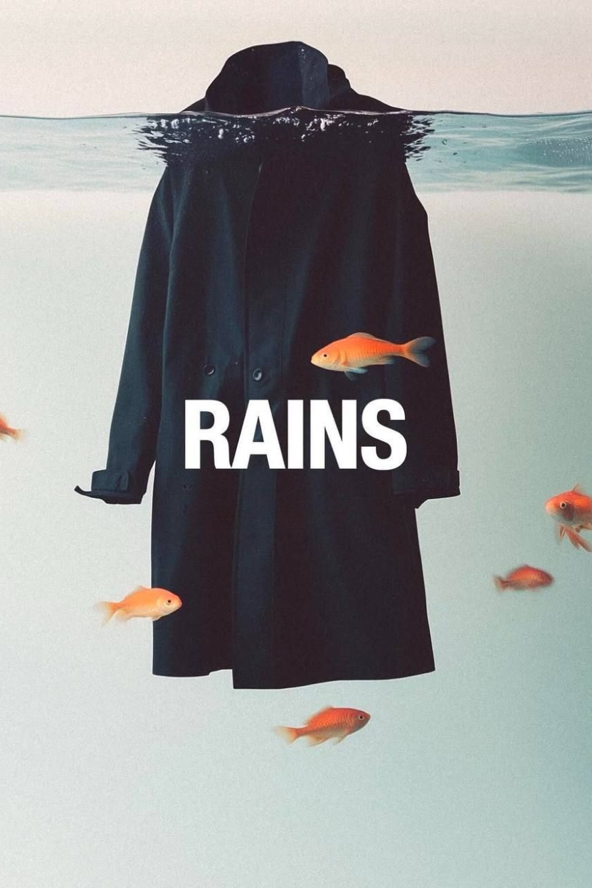 A black coat floating underwater with several small orange fish swimming around it, and the word 'RAINS' written across the coat.
