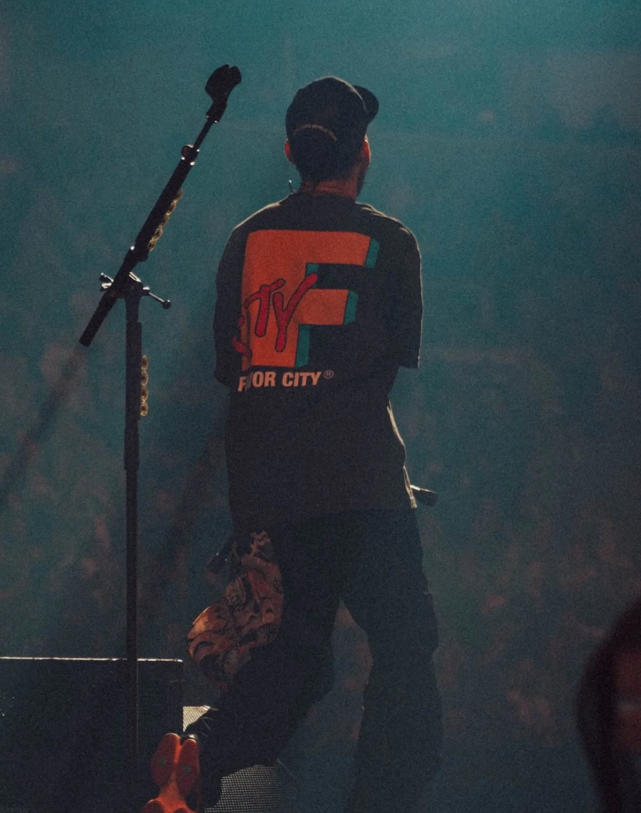 Mike Shinoda wearing Favor City FCTY short sleeve tee on tour