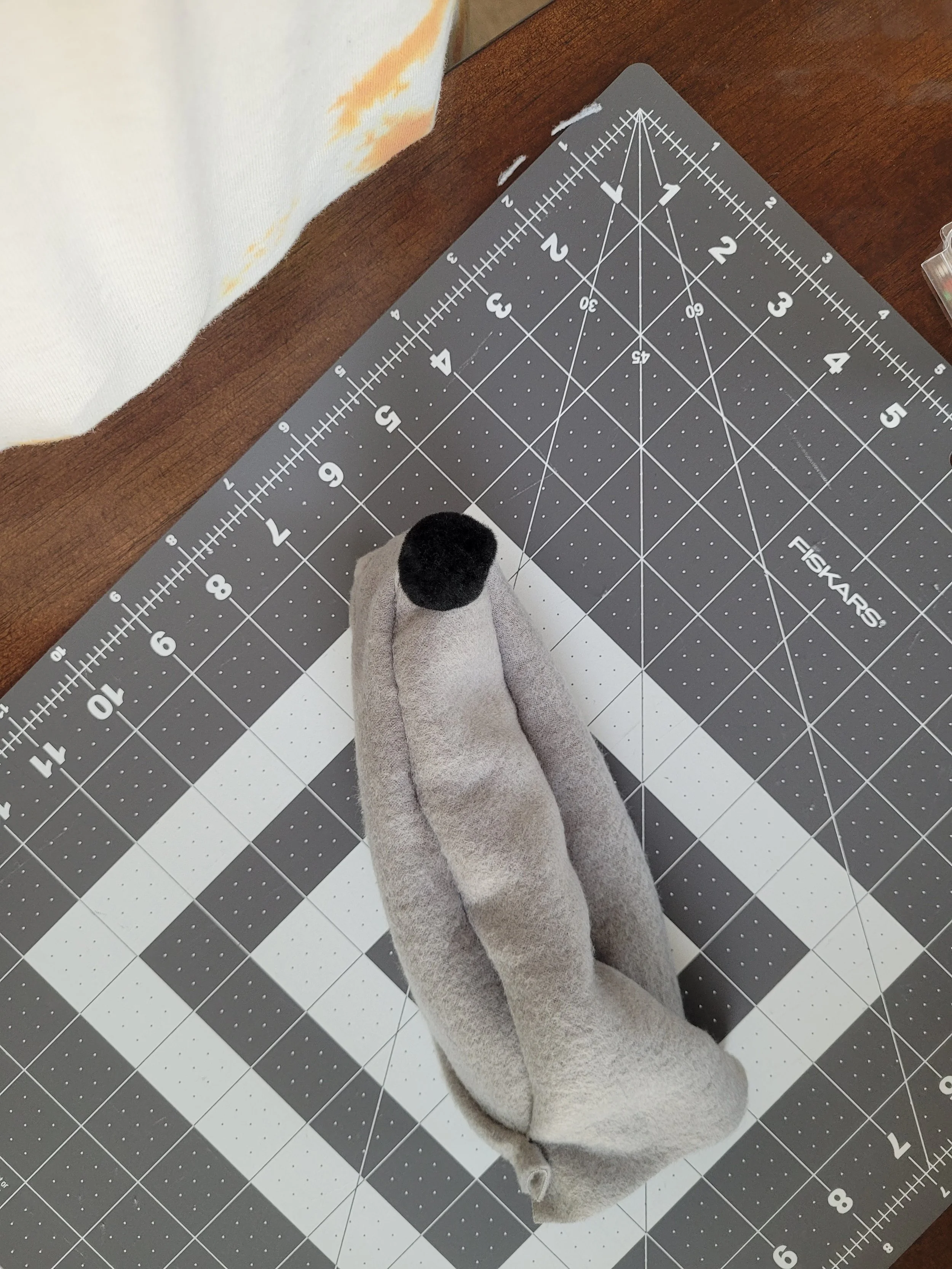 The final photo of a series of images taken as instruction for how to sew the rat bodies together, showing a sewn rat body, ready to be stuffed and finished.