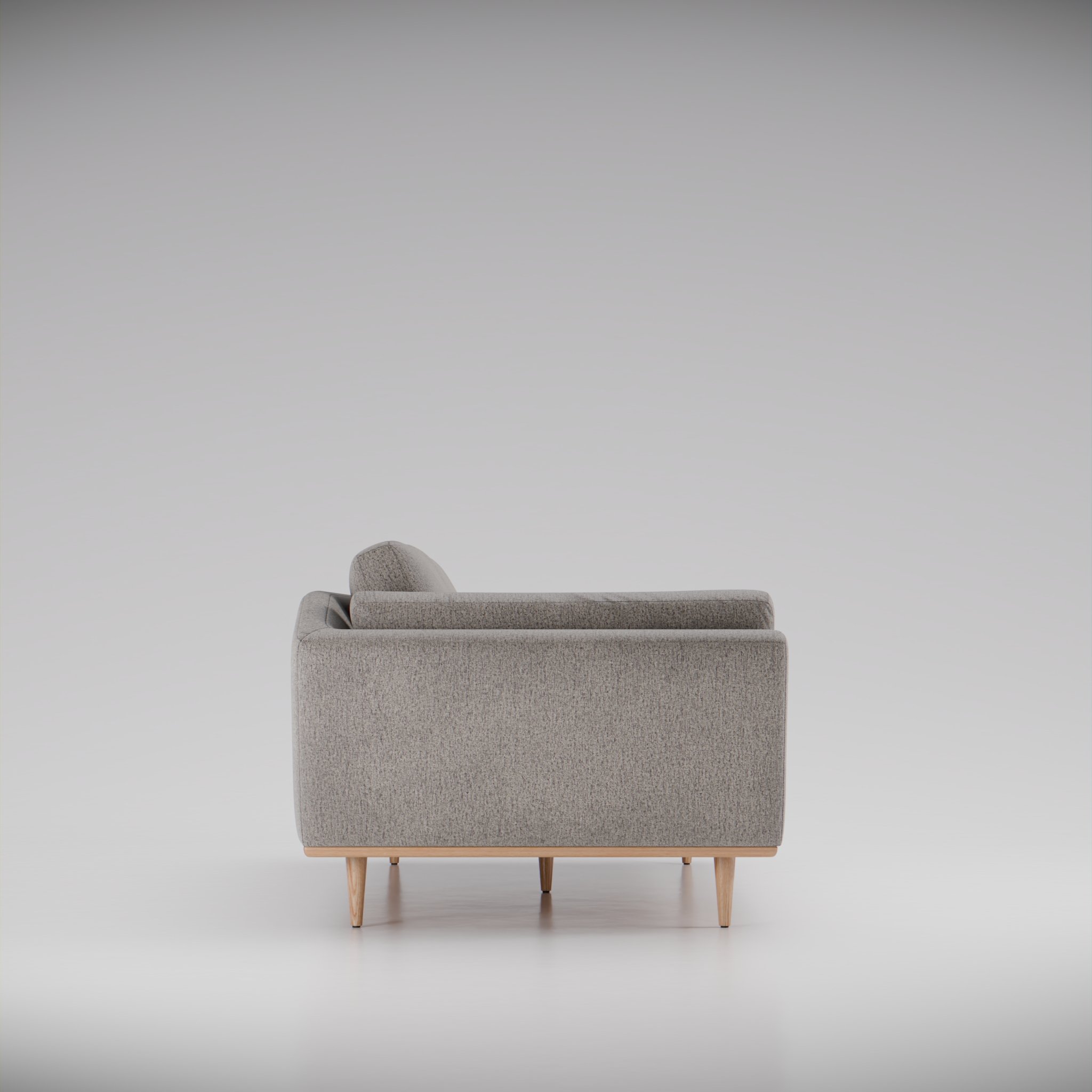 Side view of a grey fabric sofa