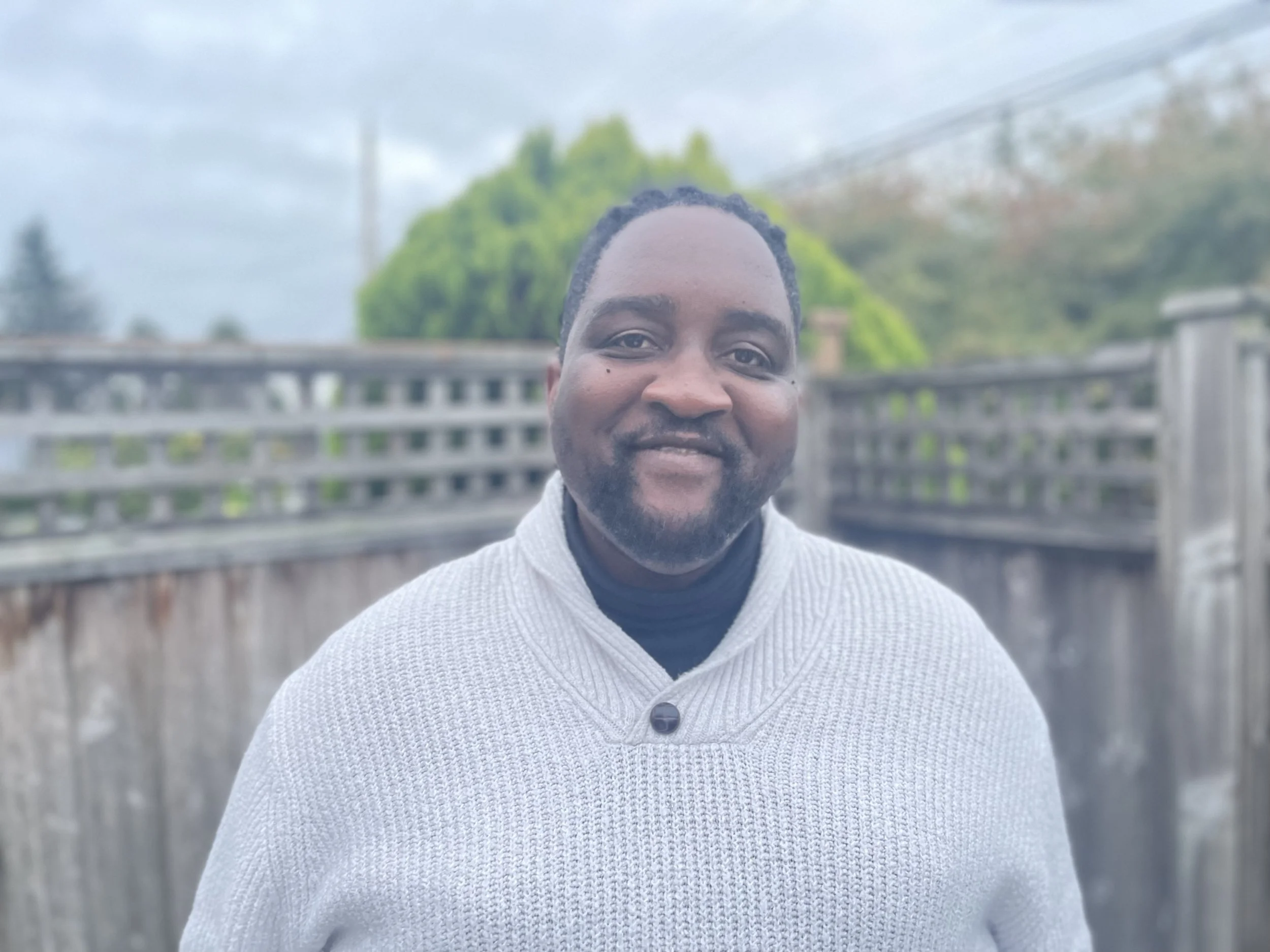Photo of young Black man smiling at the camera