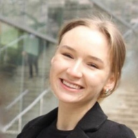 Jacqueline smiling. Staircase in background