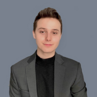 Headshot of ryan. Grey background