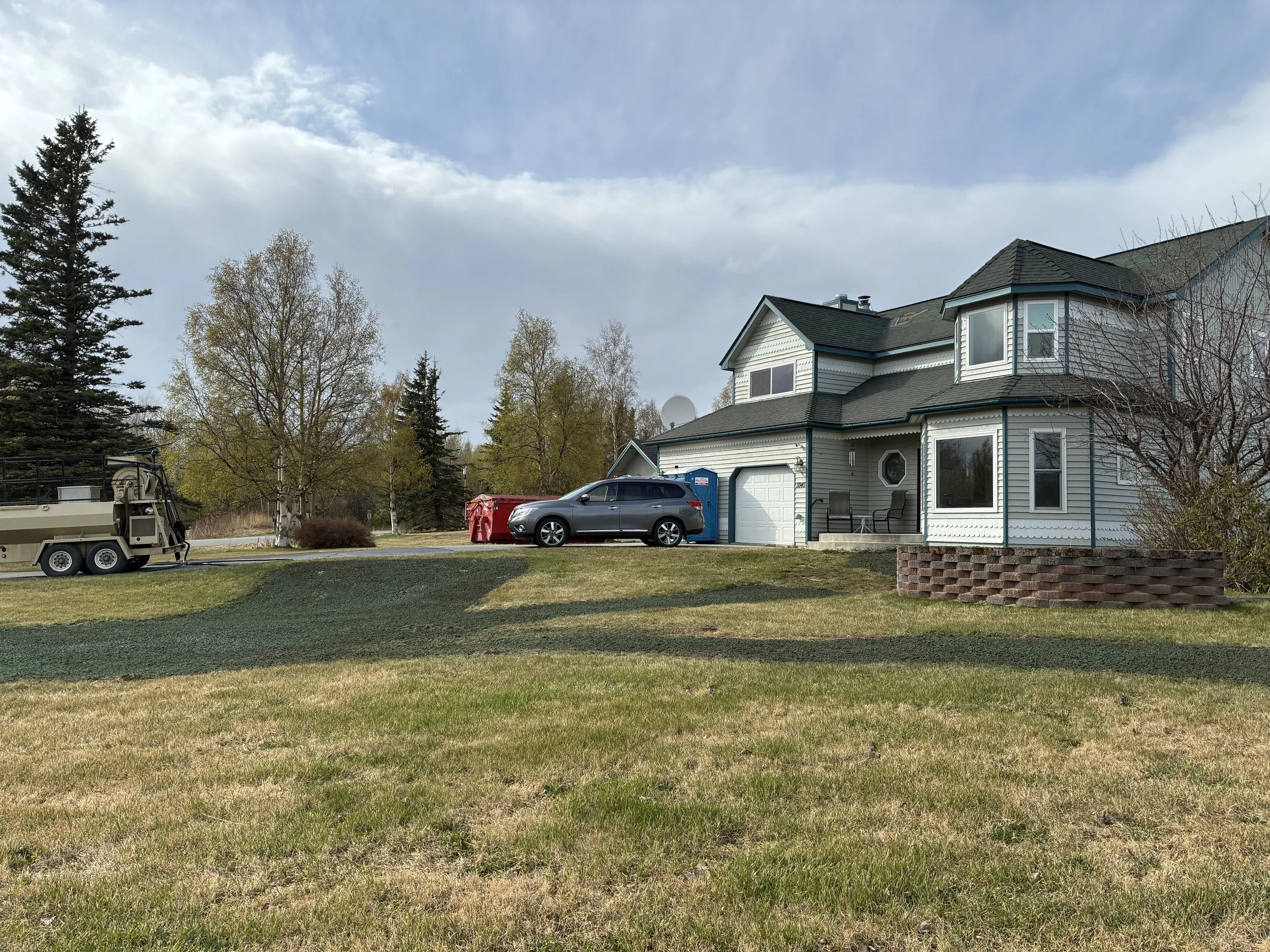 New construction yard in Alaska with grading and drainage improvements around a residential home.