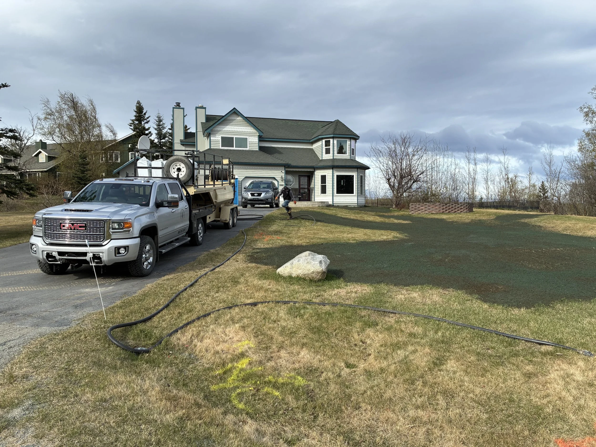 Walker Landscapes team applying grass seed during the right season in Alaska