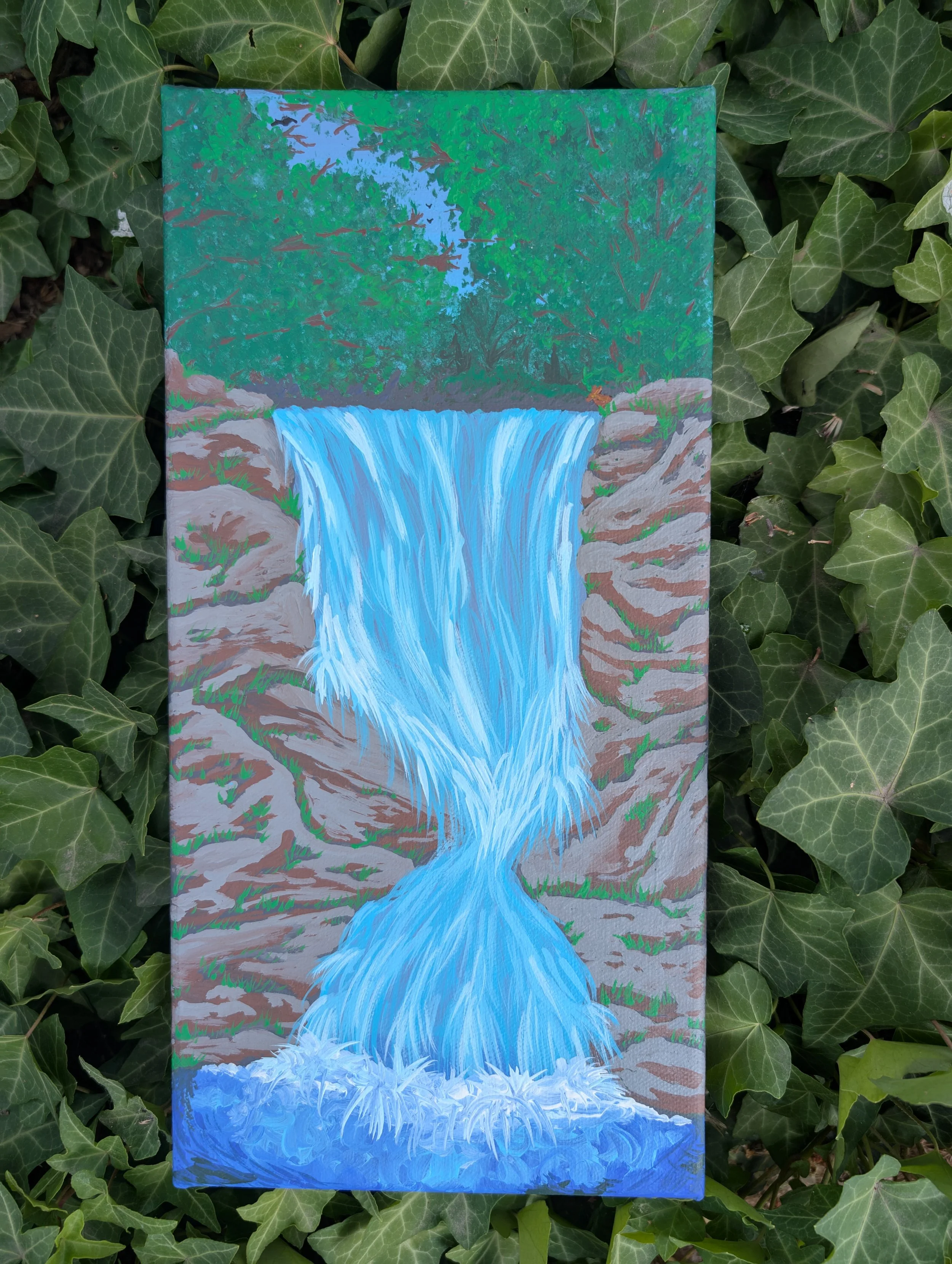 Painting of a waterfall flowing into a pool, surrounded by rocks and dense green trees.