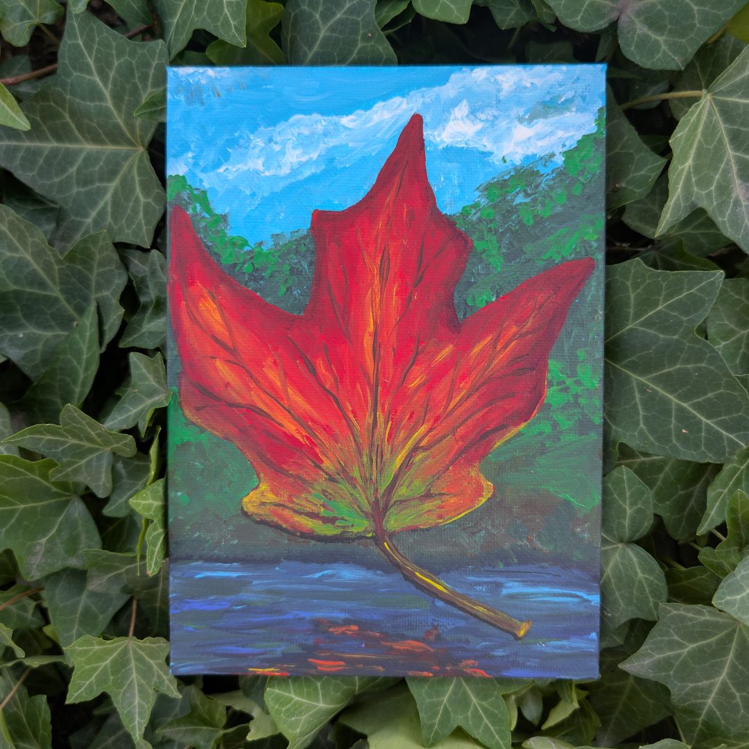 Painting of a large red maple leaf with green tips, set against a background of blue sky with clouds, green trees, and a body of water at the bottom.