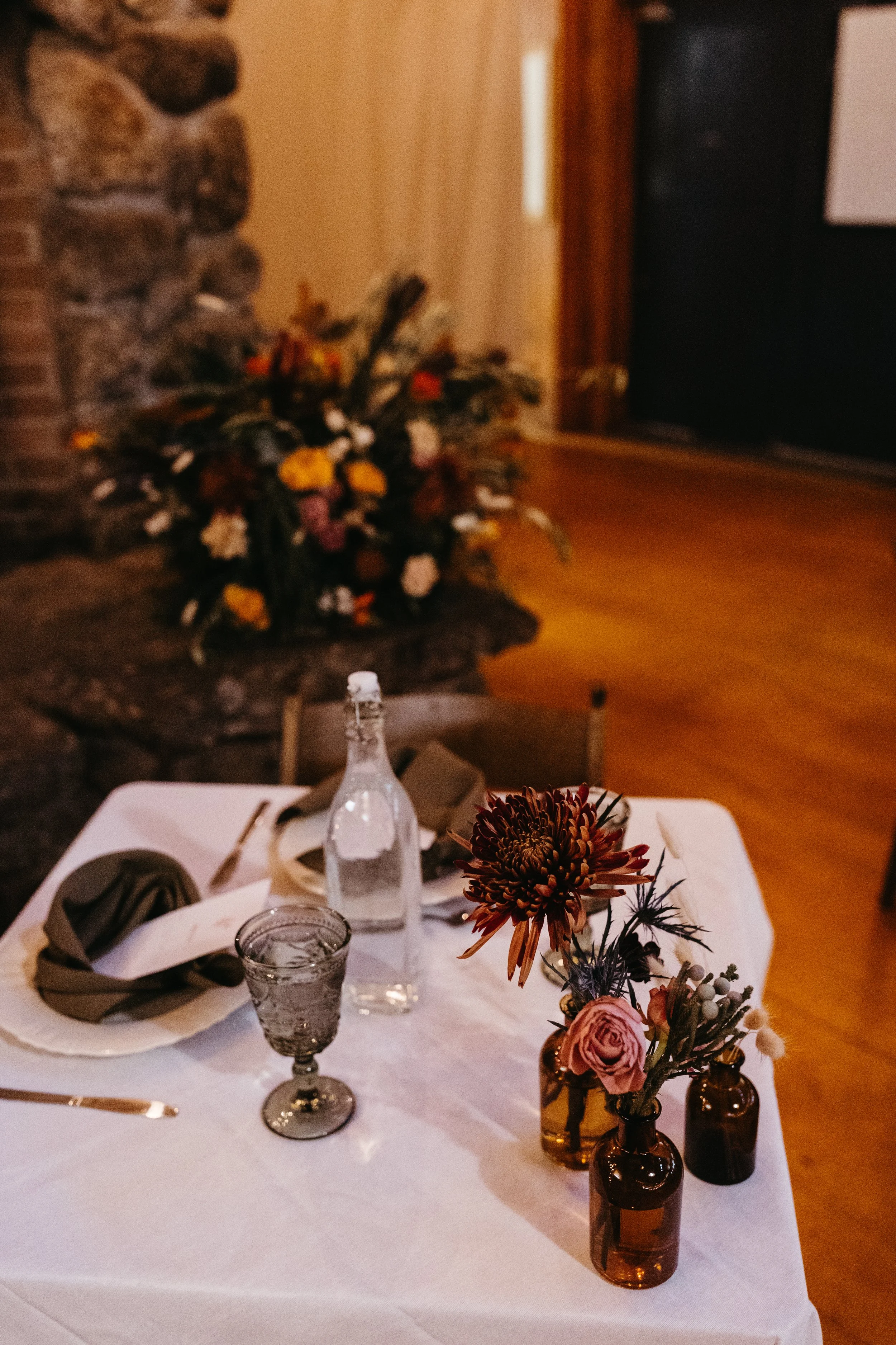 sweetheart table camp wedding with bud vases