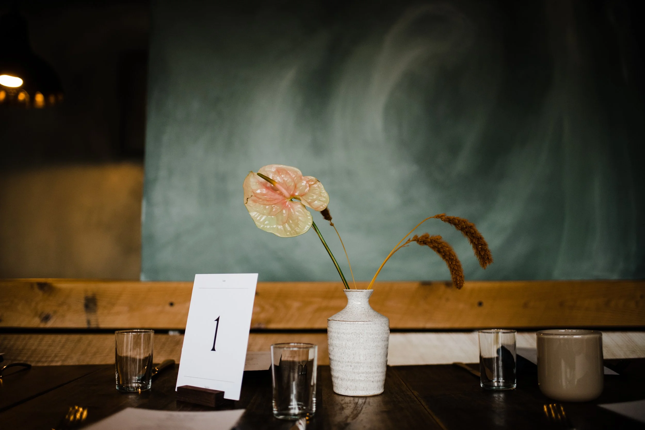 ceramic vase holding a pink anthurium